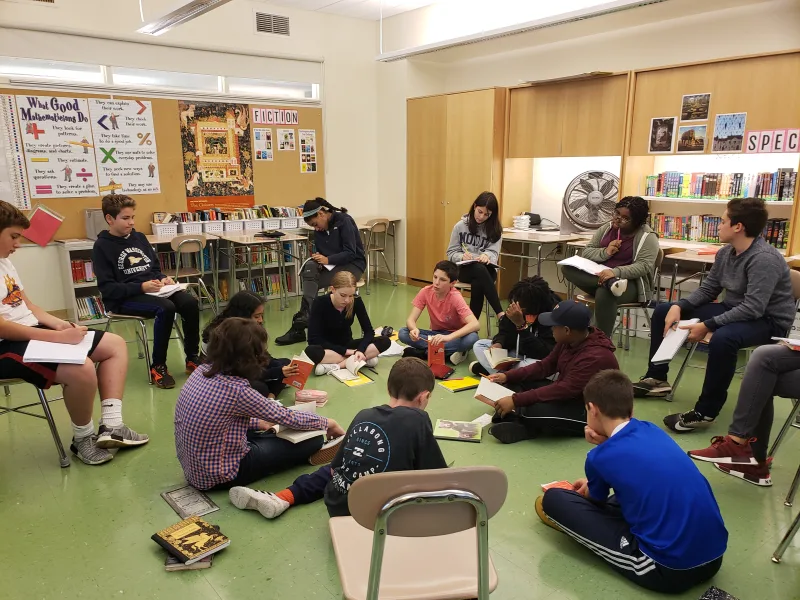 Students engaging in a “fishbowl” discussion, giving space to observe and listen to others