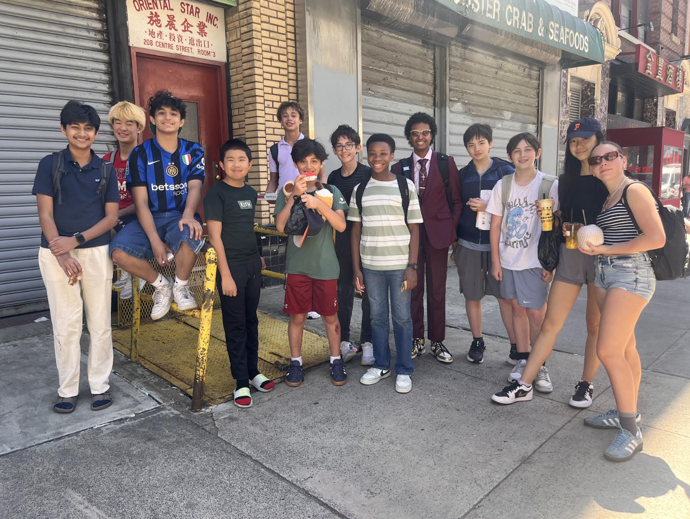 A group of ECFS Middle School students pose in Chinatown during an experiential learning trip