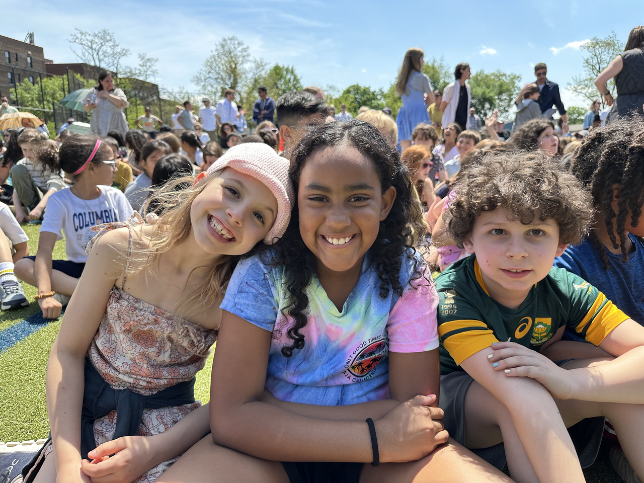 ethical culture fieldston school; fieldston lower students smile together at Spring Festival
