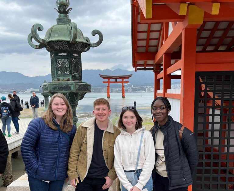 ECFS students on a spring trip, standing before the torii gate at Itsukushima in Japan