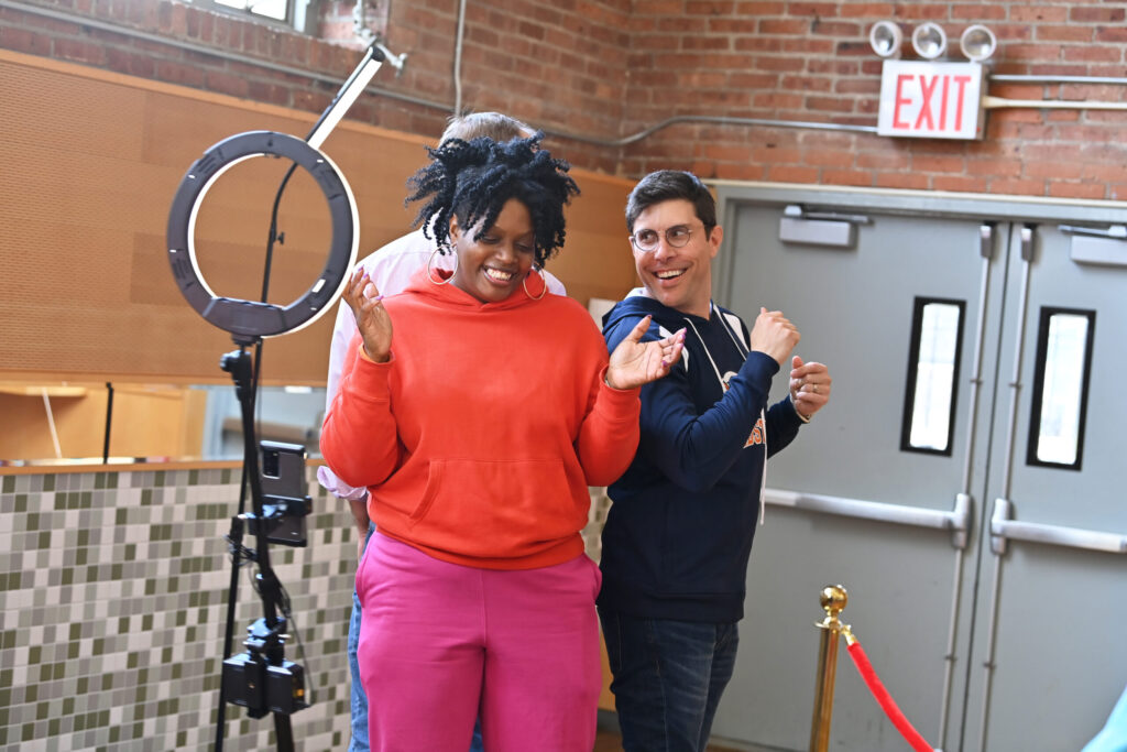 A group of adults poses for a spinning Photo Booth