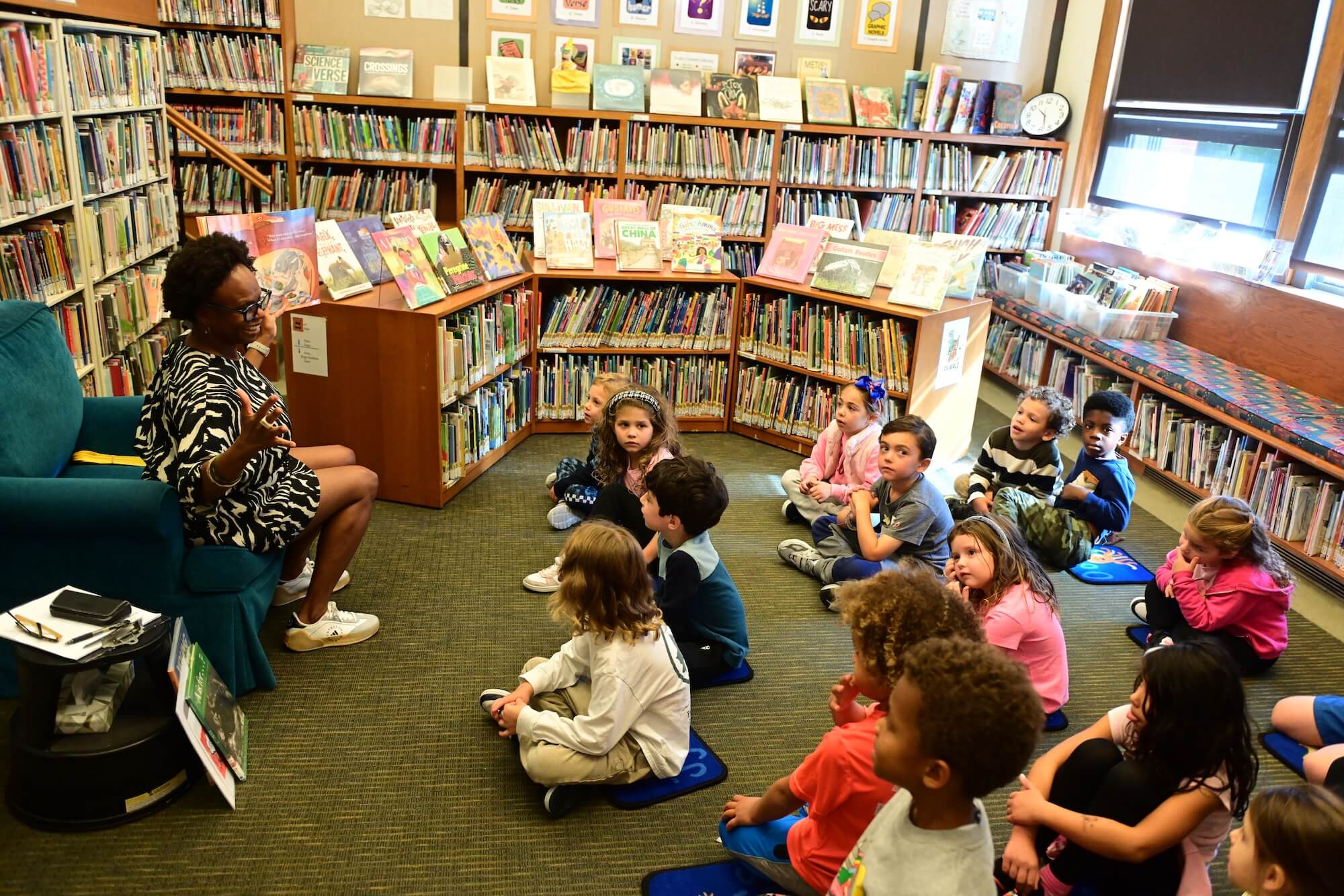 Students at Ethical Culture listen to a read-aloud in the library.