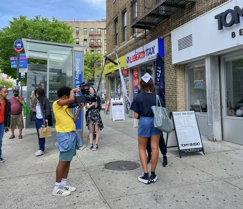 Students film outside of building