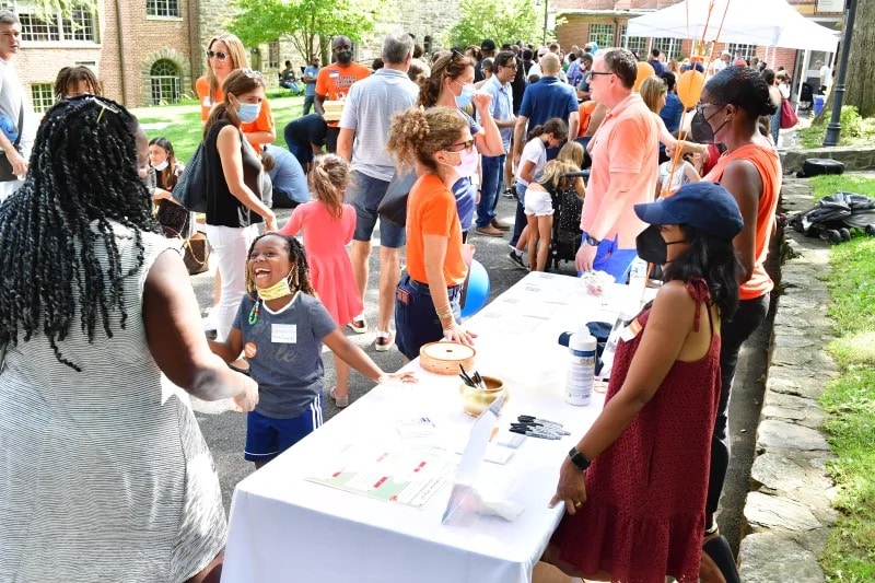 People gather outside at volunteer barbecue