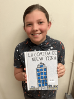 Ethical Culture Fieldston School student holds book project and smiles