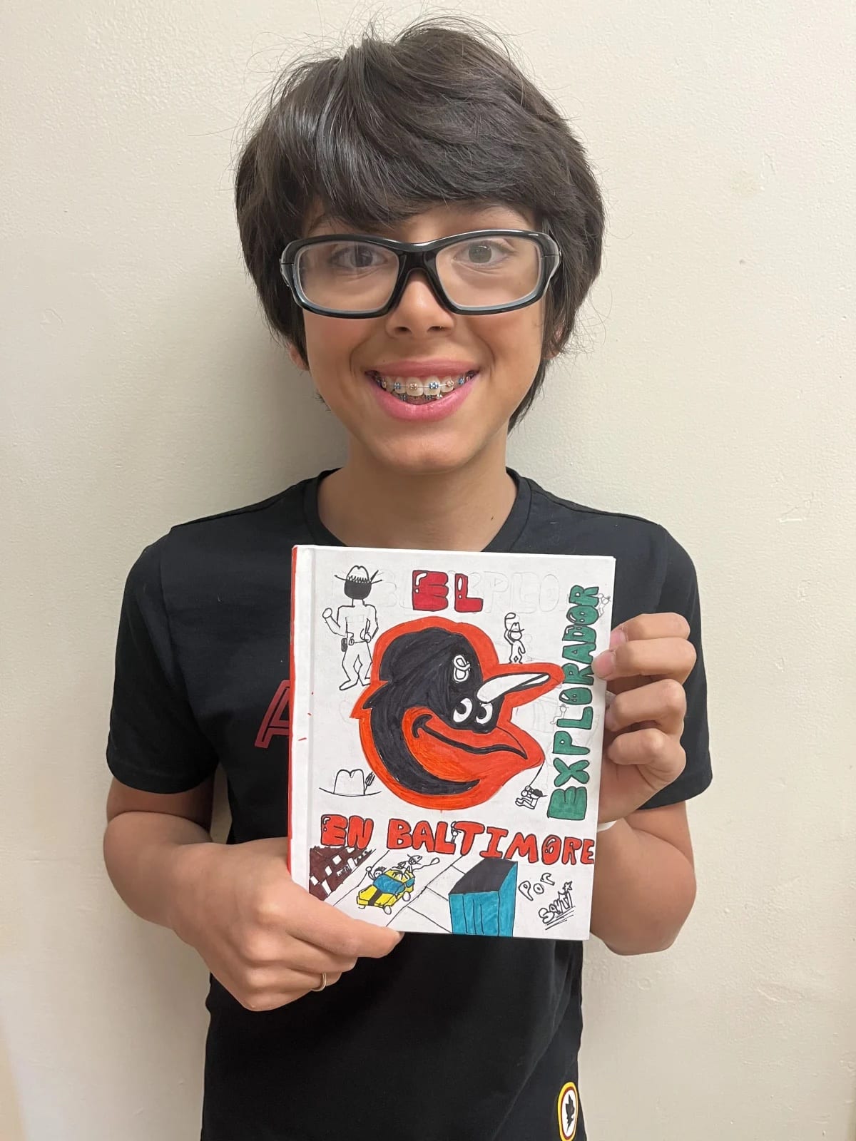 An Ethical Culture Fieldston School 5th Grade student holding a book they designed