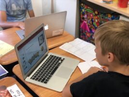 An Ethical Culture Fieldston School 5th Grader researches on a laptop