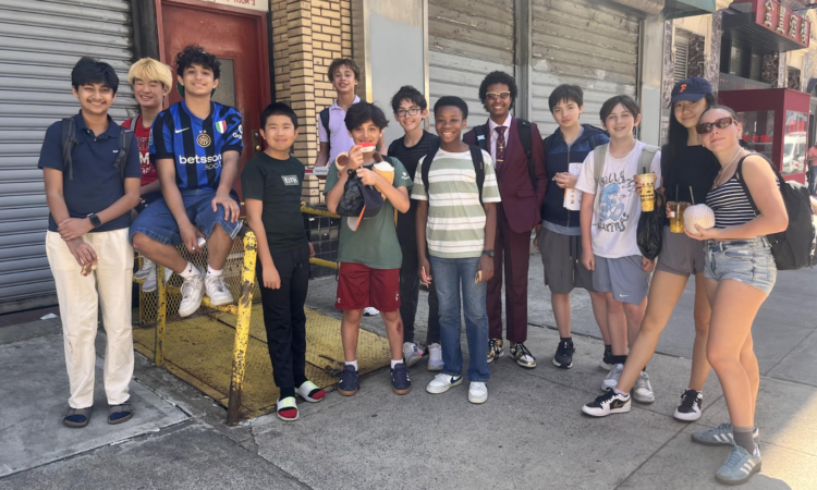 A group of ECFS Middle School students pose in Chinatown during an experiential learning trip