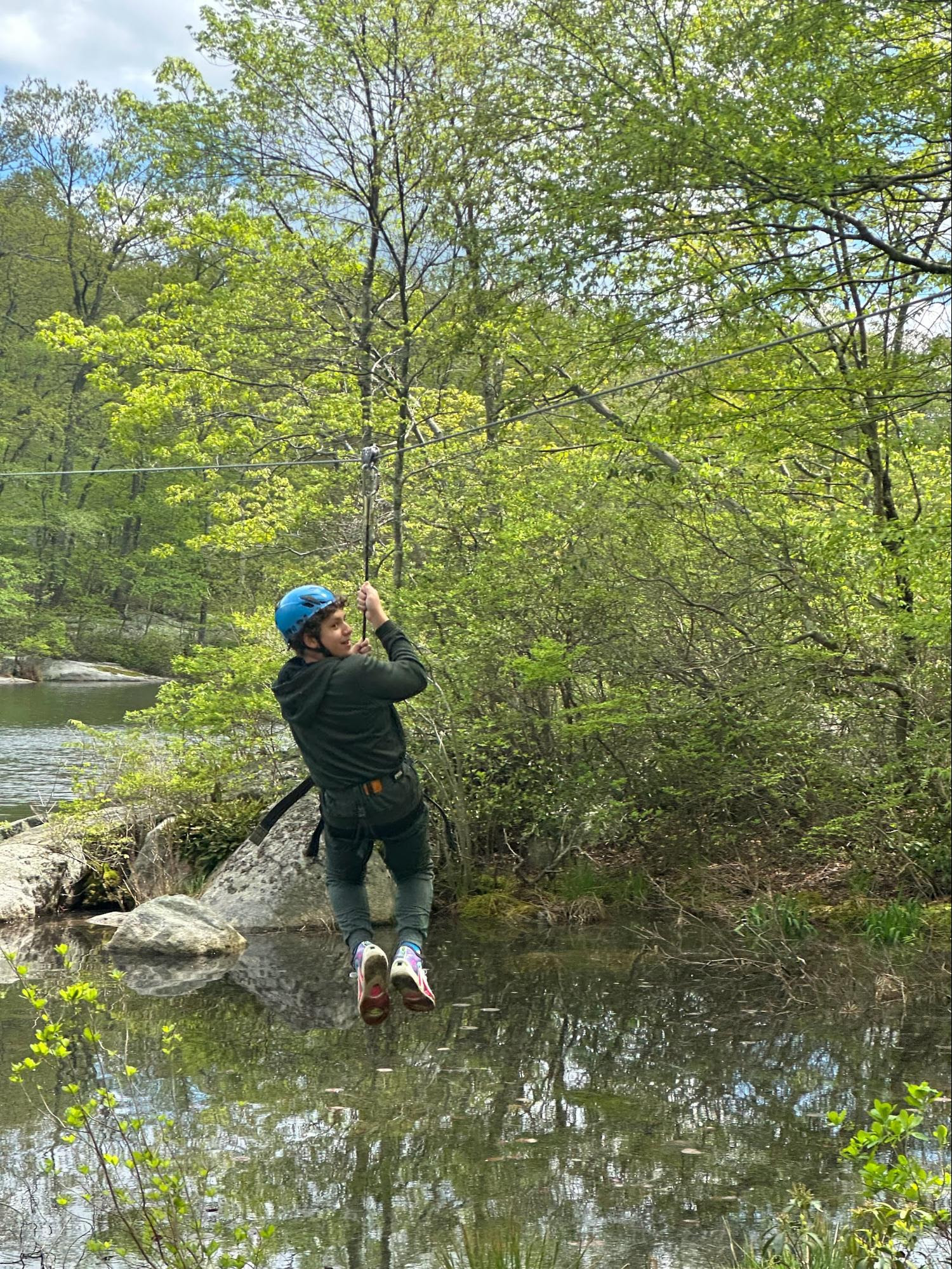 An ECFS 7th Grade student ziplines during an experiential learning trip