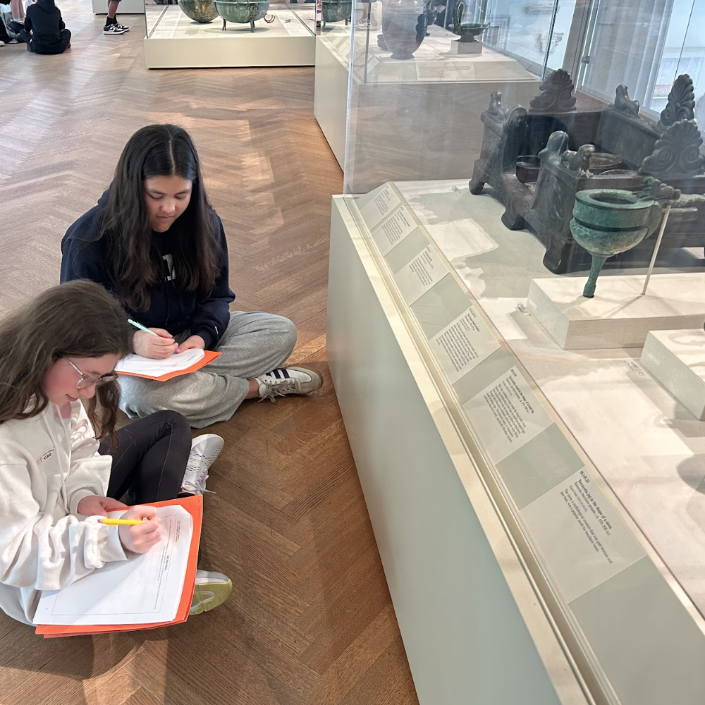 Two ECFS Middle School students draw an artifact during an experiential learning trip to the Met