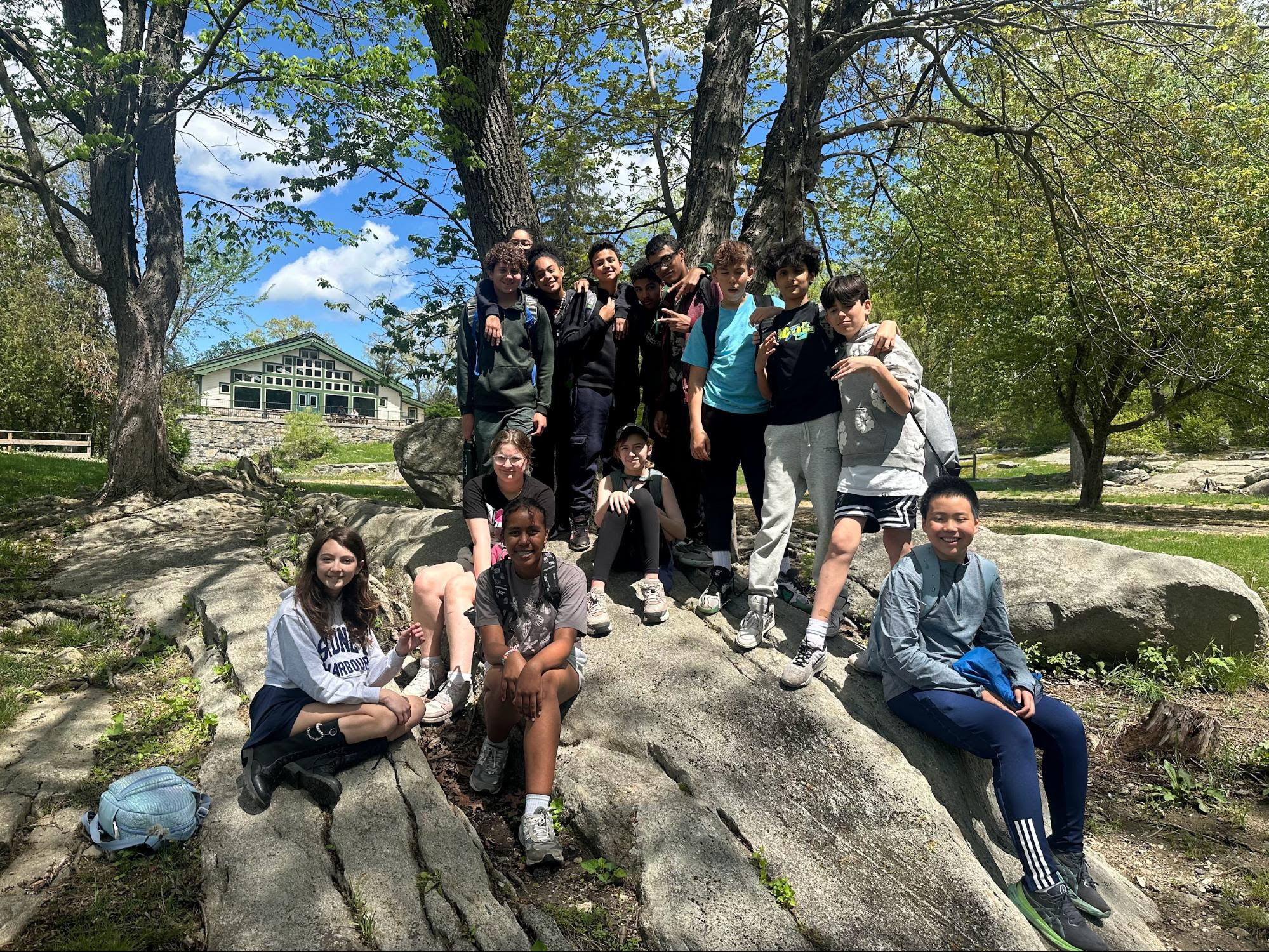 A group of ECFS 7th Graders smile during an experiential learning trip