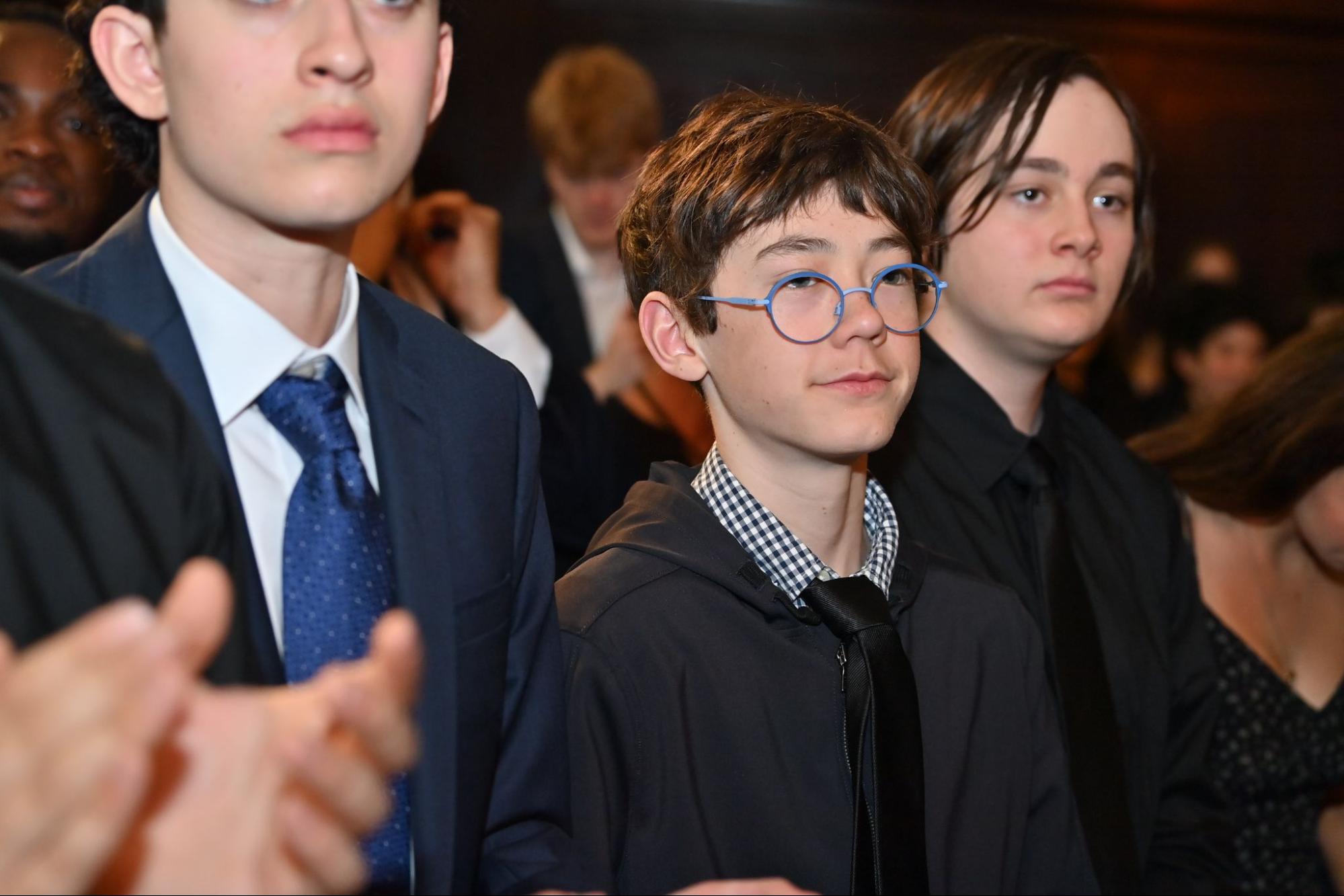 Two ECFS Middle School students watch from the audience during Founder's Day