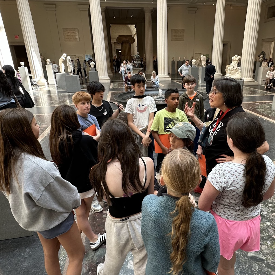 ECFS Middle School students listen to a tour guide during an experiential learning trip to the Met