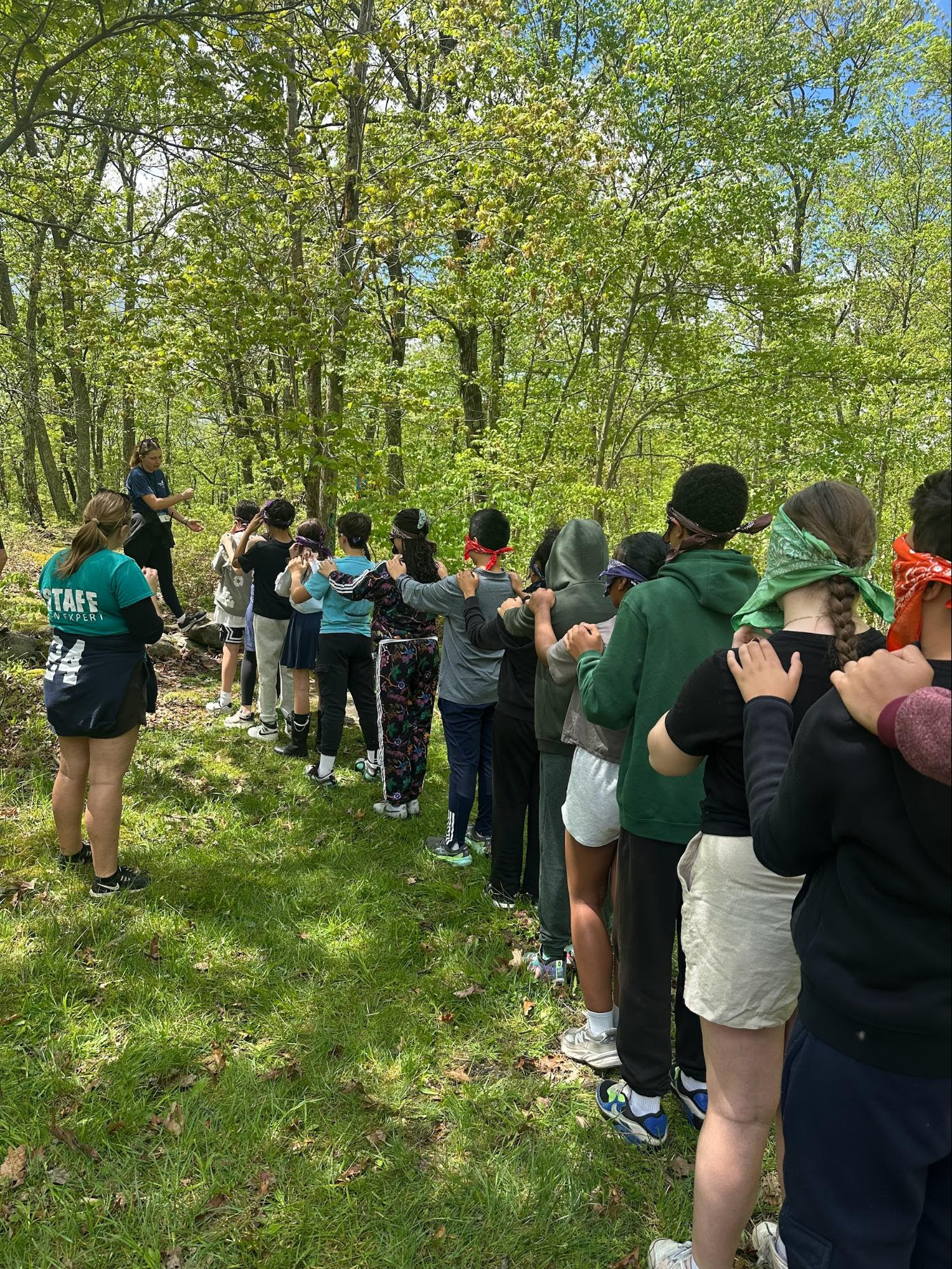 A group of ECFS 7th Grade students participate in a team building activity during an experiential learning trip