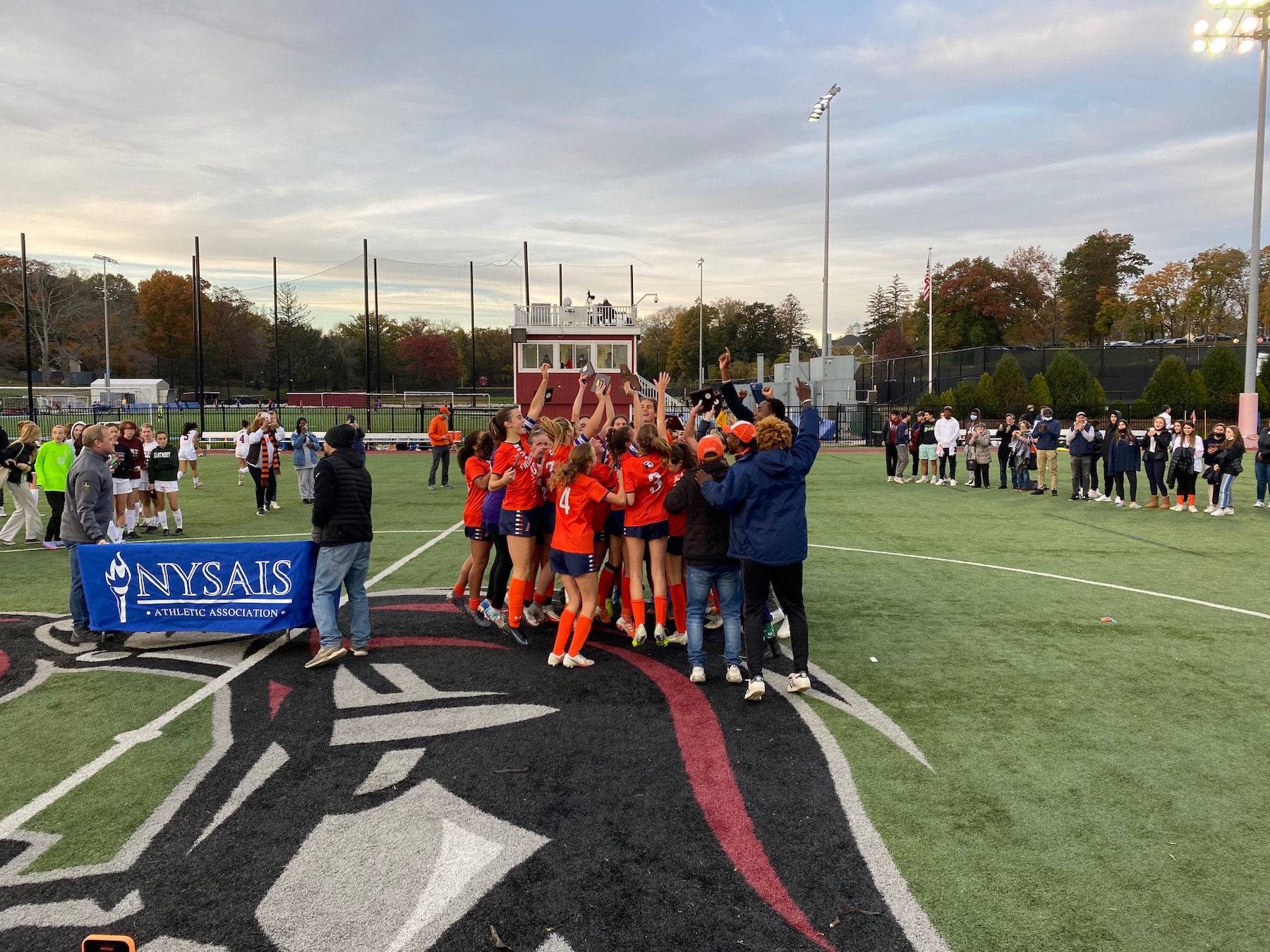 Ethical Culture Fieldston School group of Upper School soccer players celebrate in a group