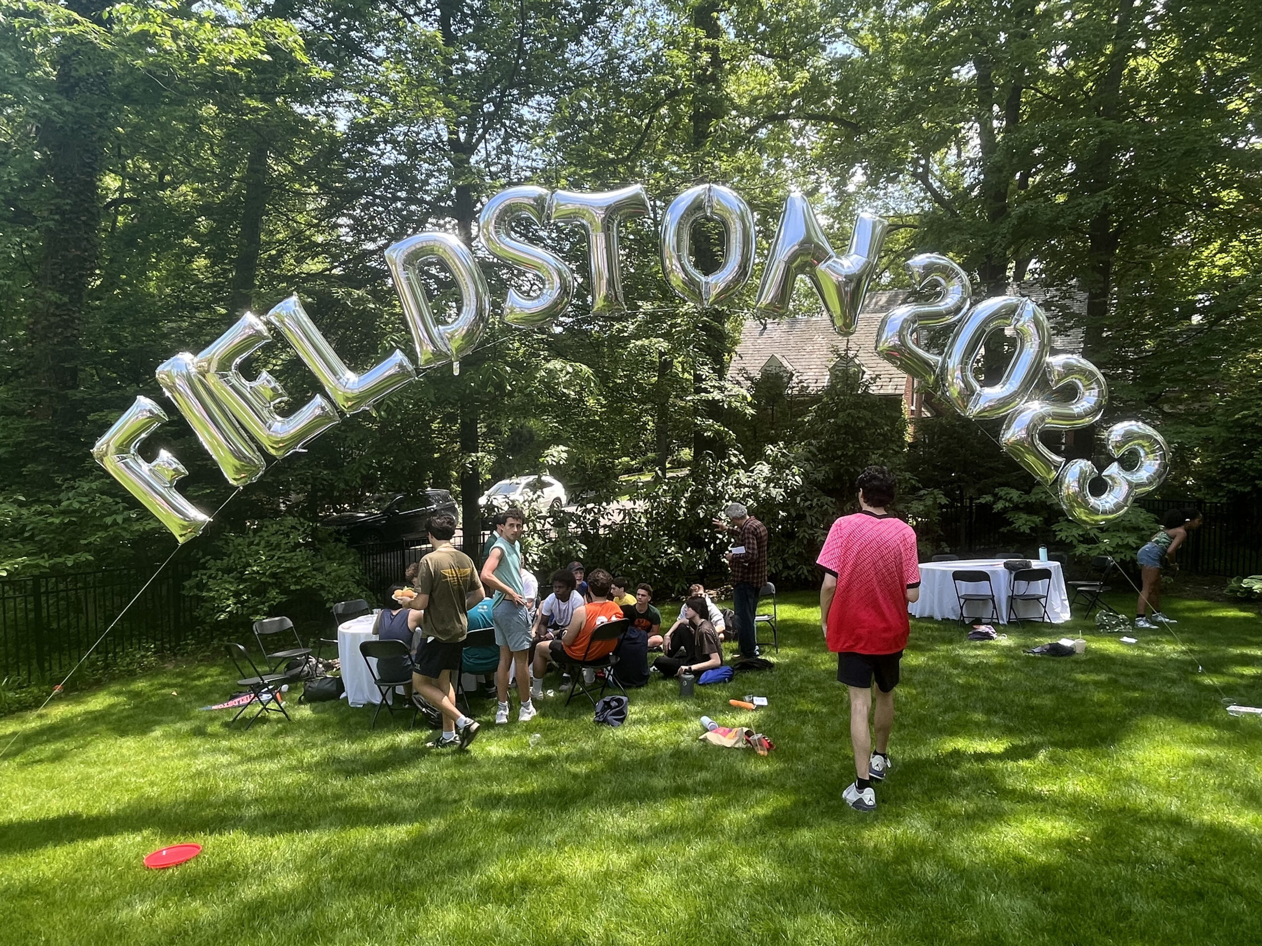 Silver balloons that spell out "Fieldston 2023" are displayed at the senior barbecue