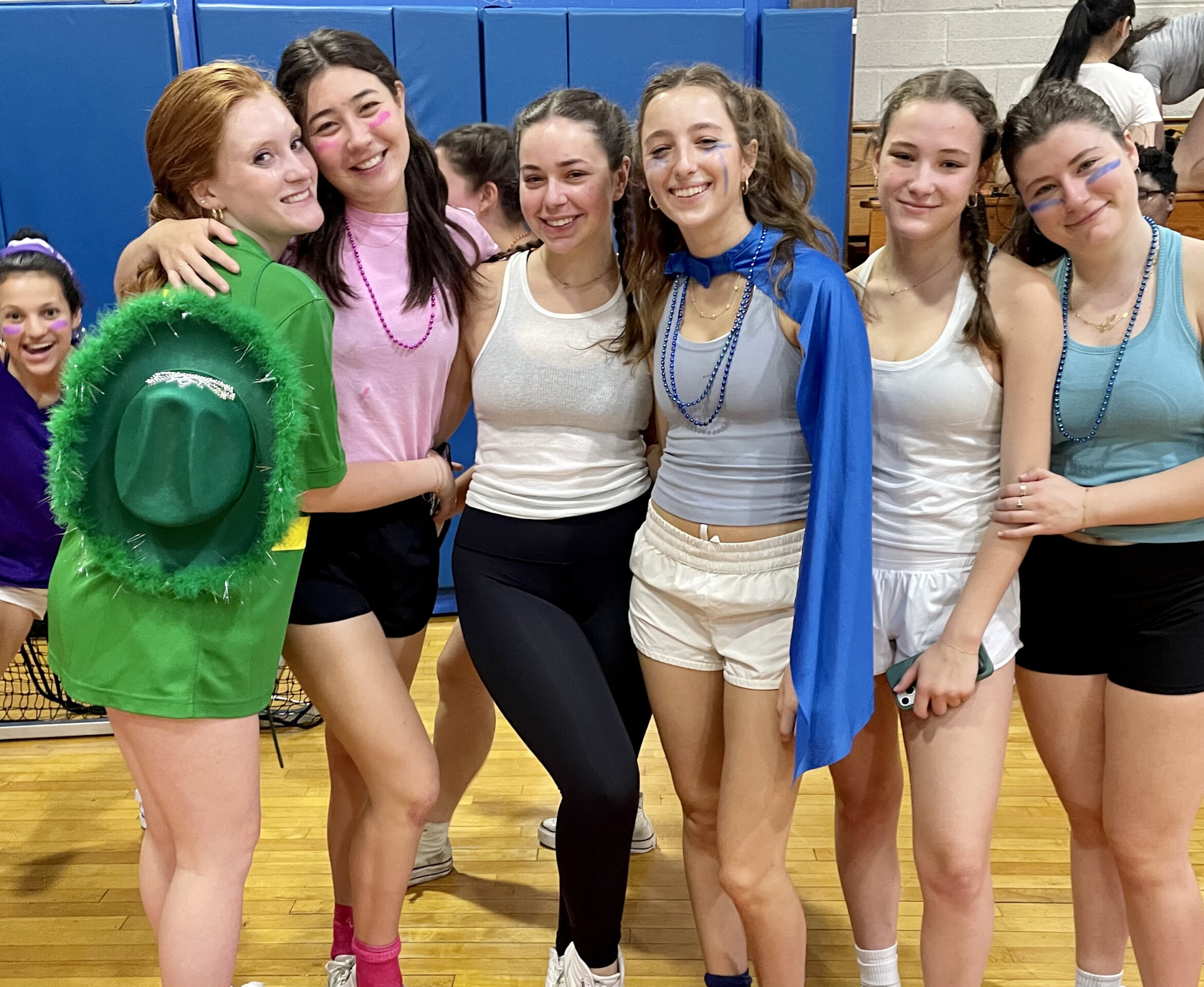 A group of students pose together in the Varsity Gym on Field Day