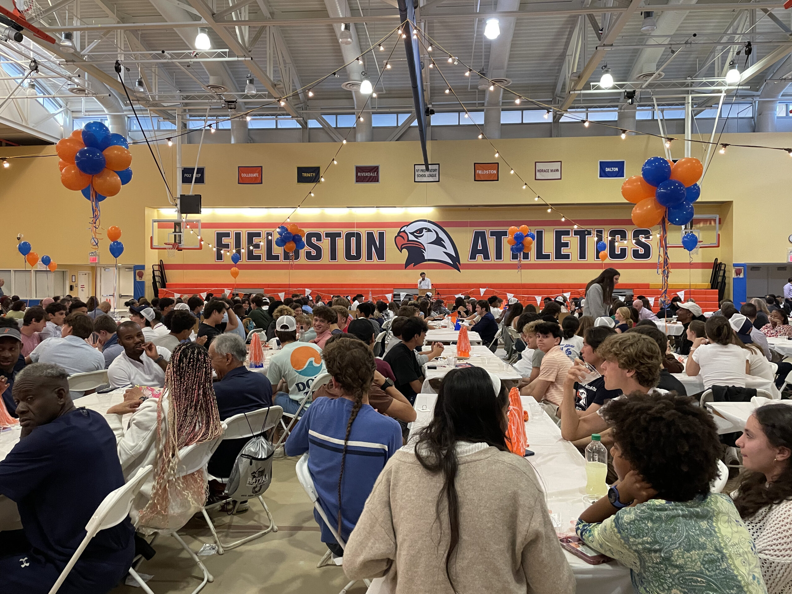 Students and families gather in the Varsity Gym for the Sports Dinner