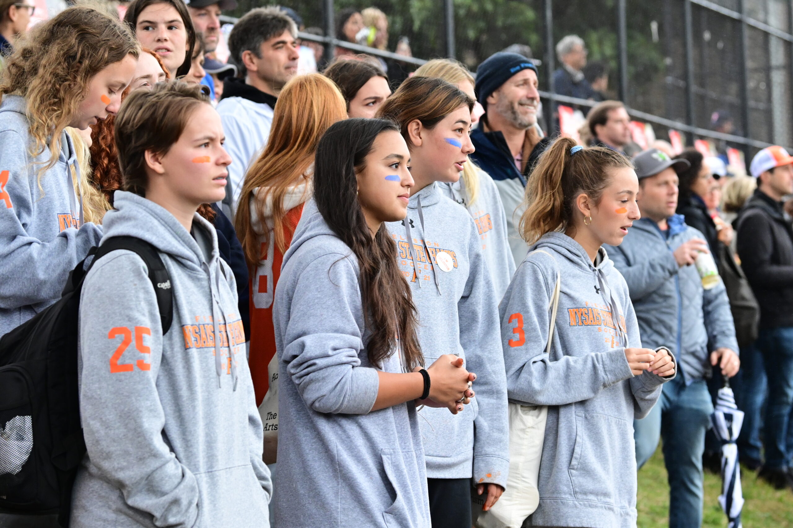 Students watch from the sidelines at Homecoming