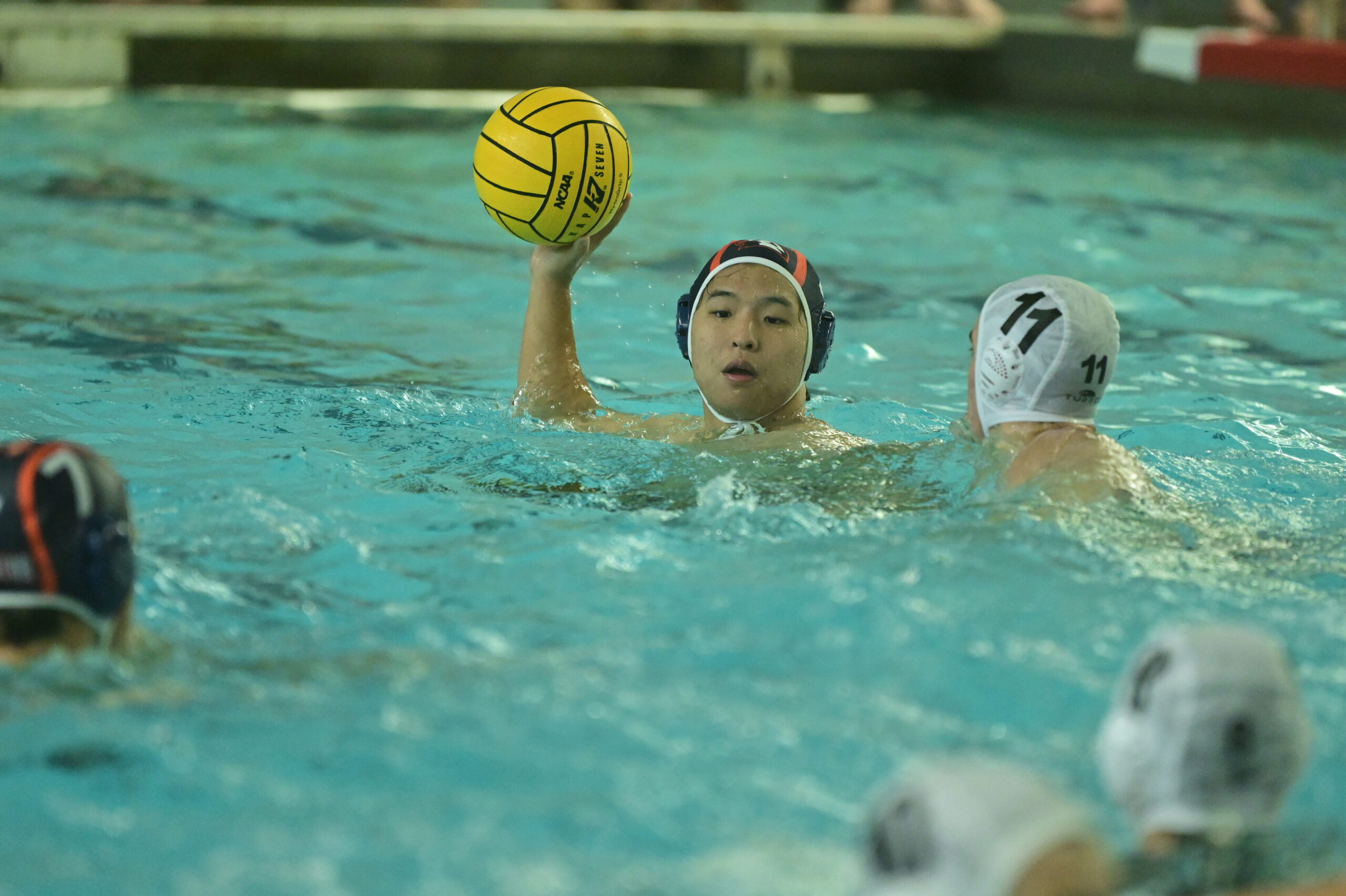 A waterpolo player gets ready to throw the ball during a game
