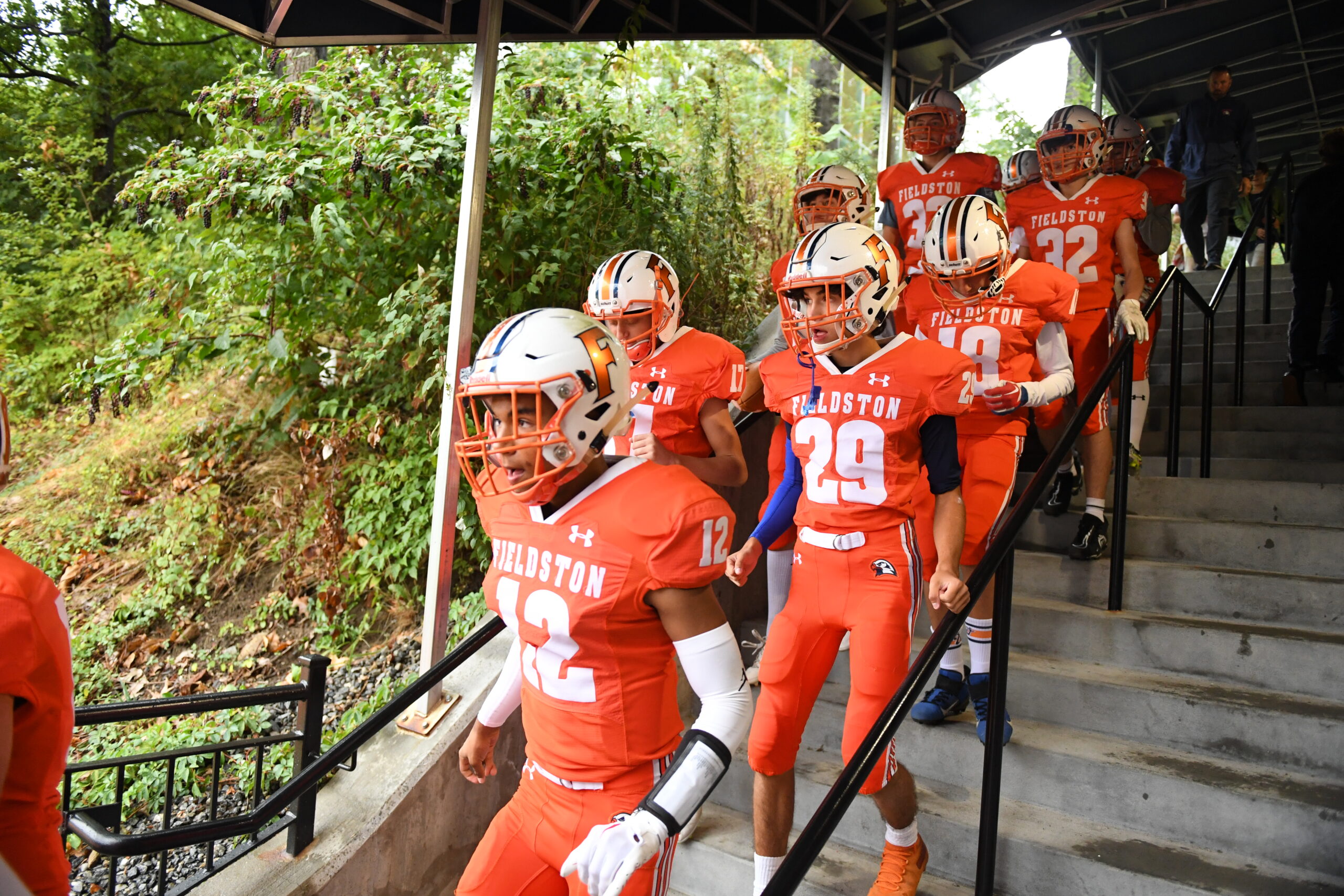 The Fieldston football team descends the steps towards the upper field