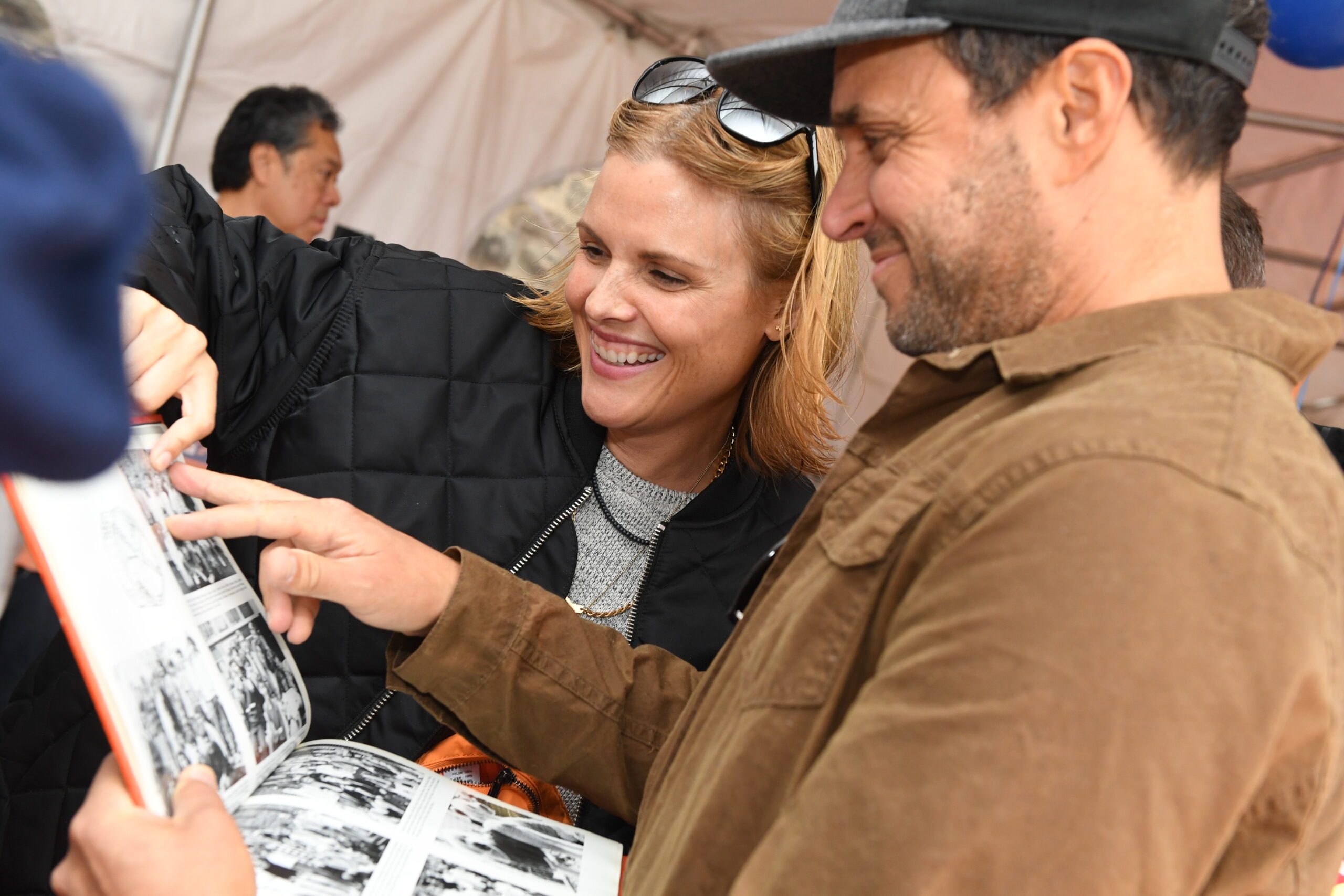 Alumni look at photos in yearbooks from their time at the Ethical Culture Fieldston School