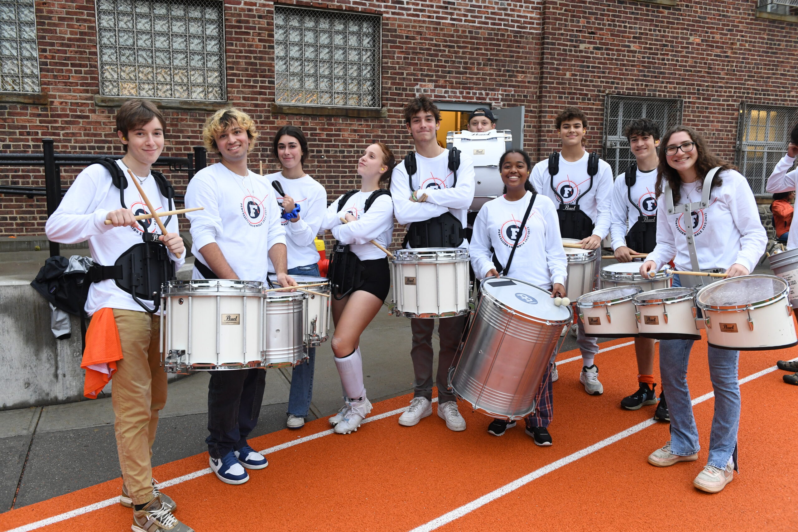 The Fieldston percussion band poses with their instruments at Homecoming 2022