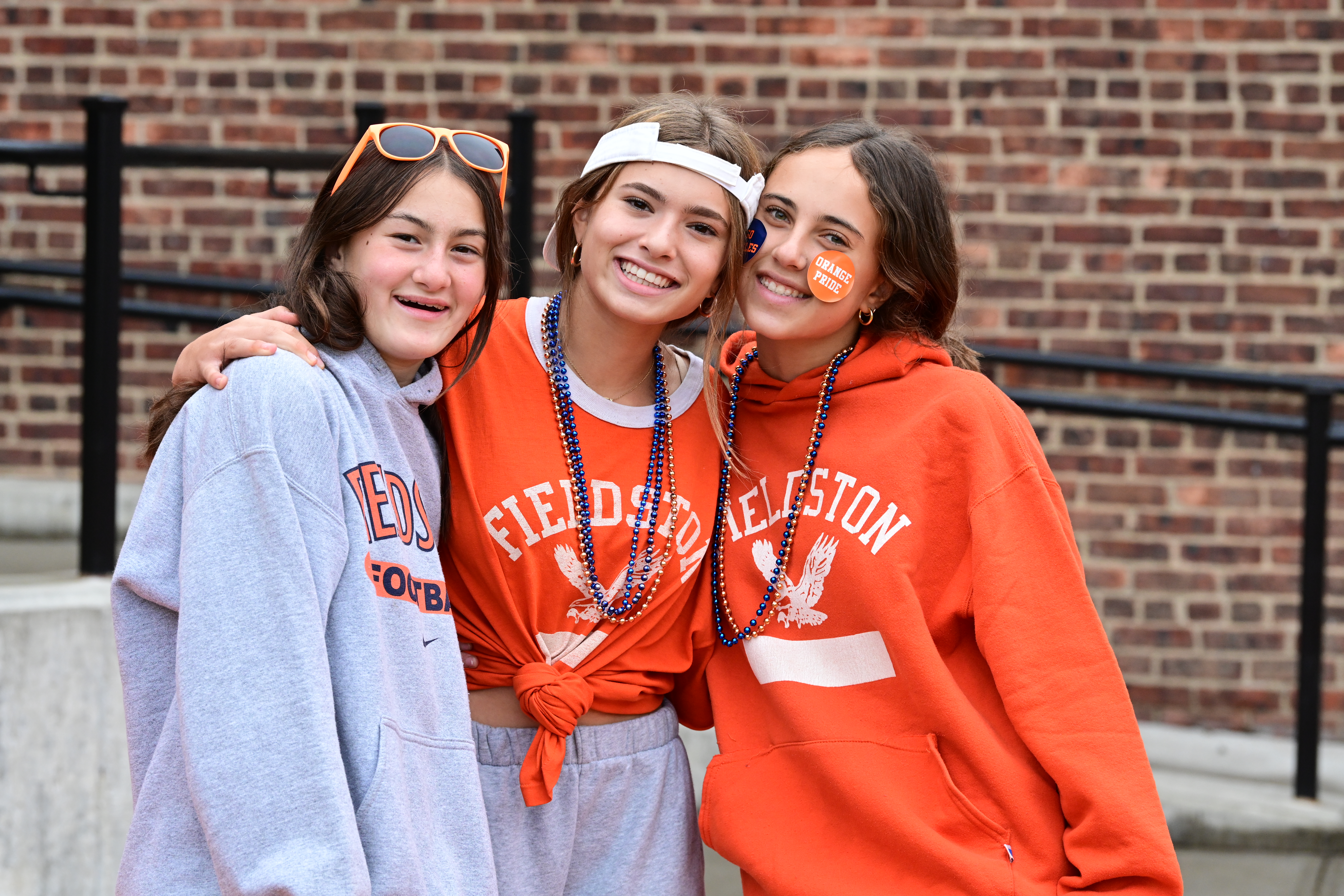 Three students pose in orange ECFS shirts