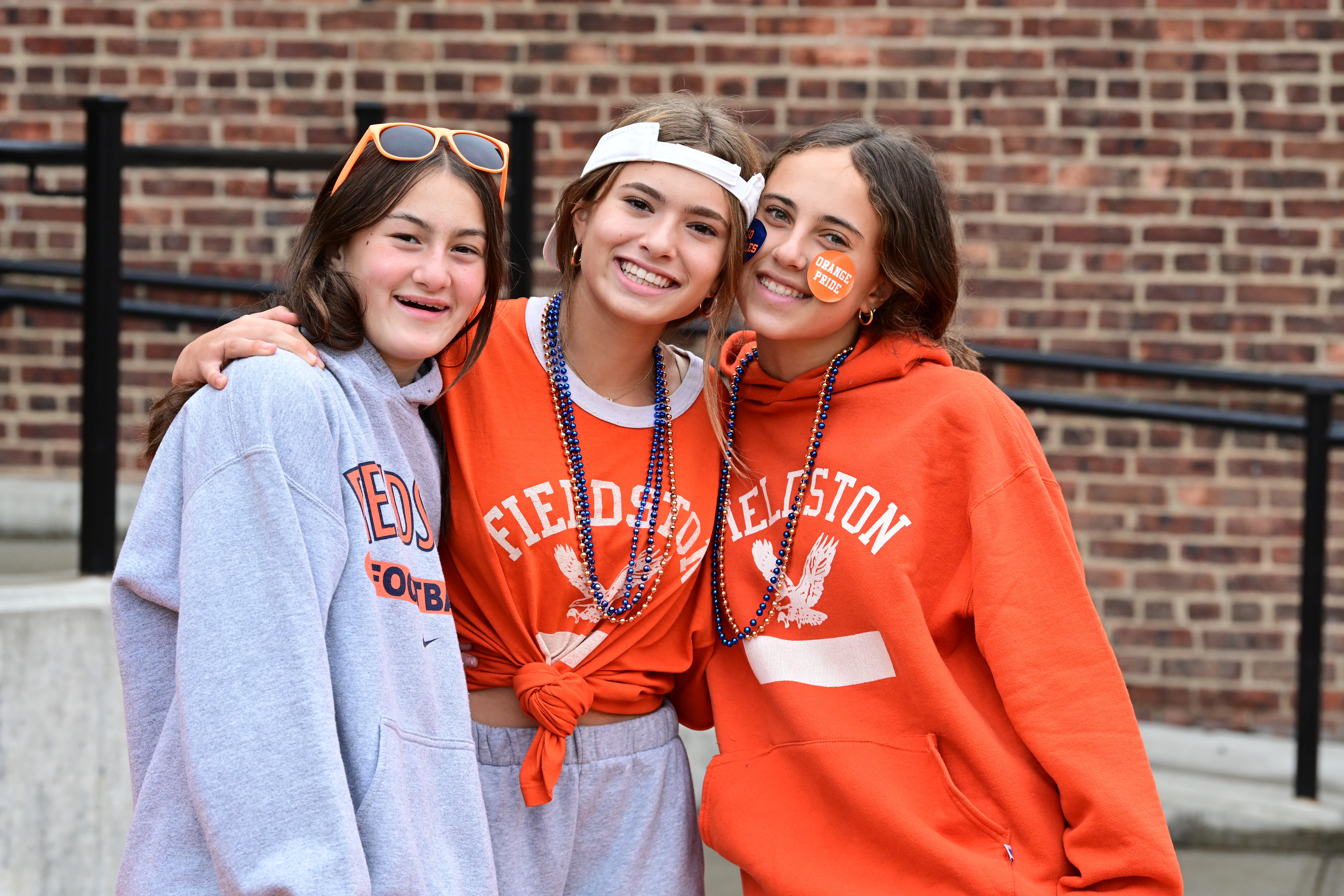 Three students pose in orange ECFS shirts