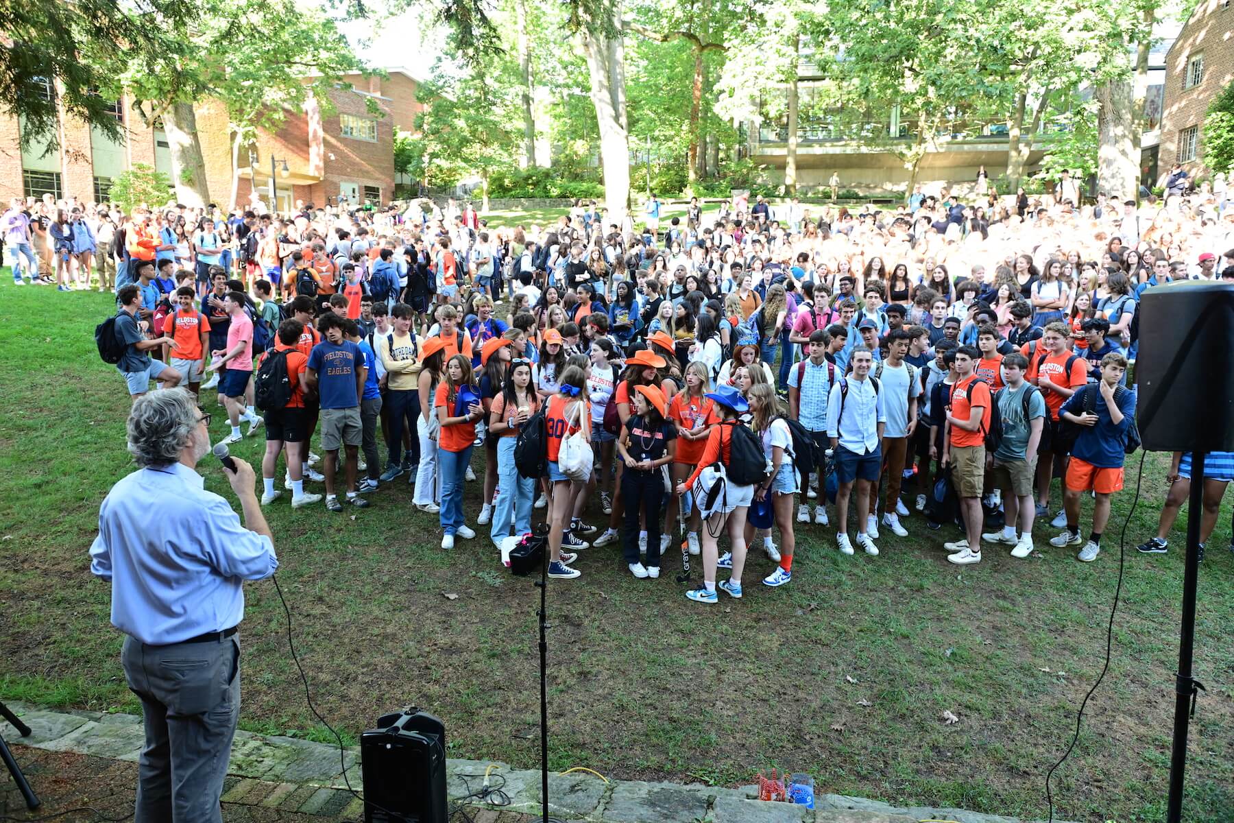 Ethical Culture Fieldston School Joe Algrant speaking to large group of upper school students on the quad