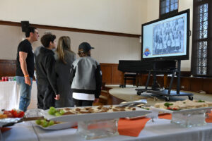 Families watch slideshow at Title IX reception.