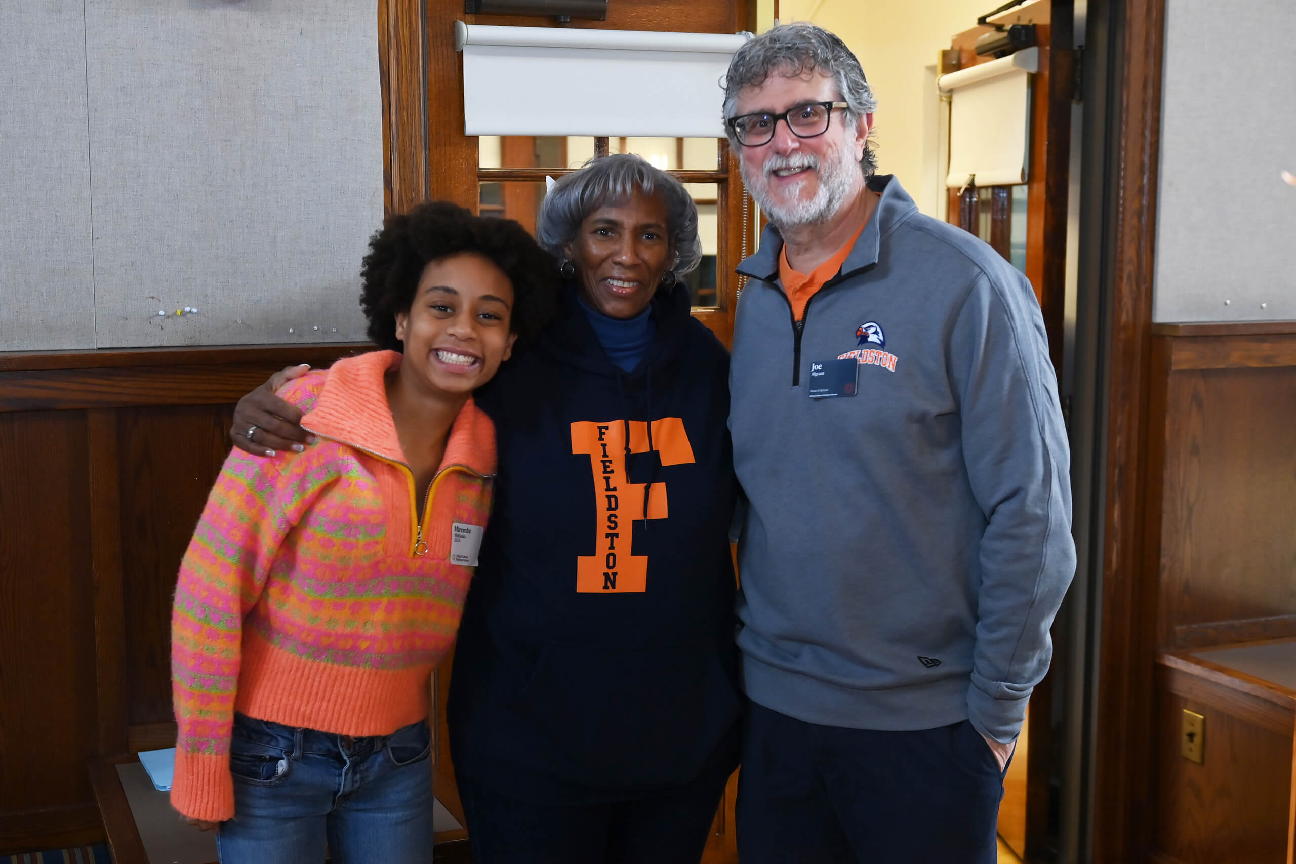 Fieldston Upper student smiles with administrator Janet Pugh and Head of School Joe Algrant after Title IX reception.