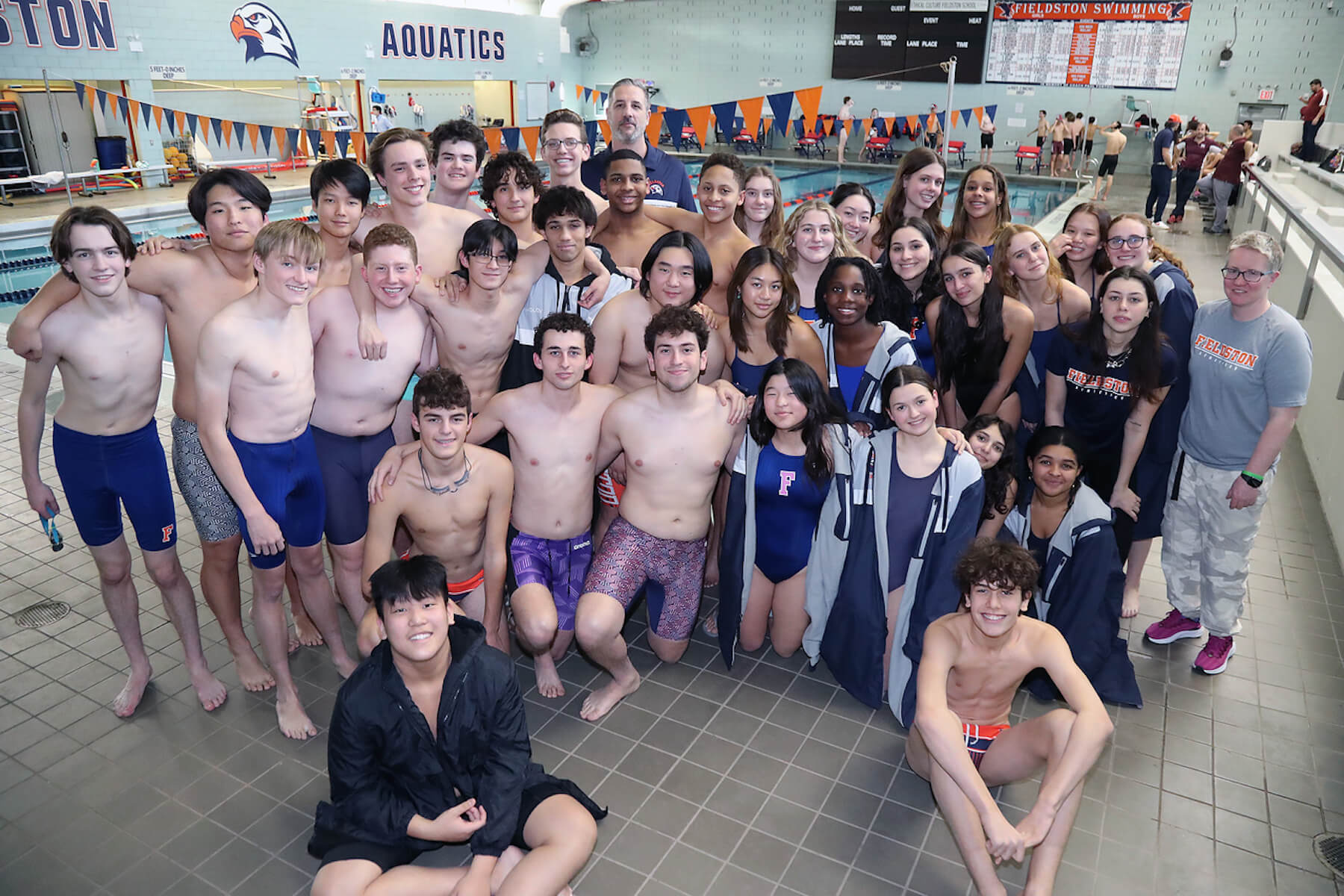 Fieldston Upper swim team poses for group photo in front of the pool.