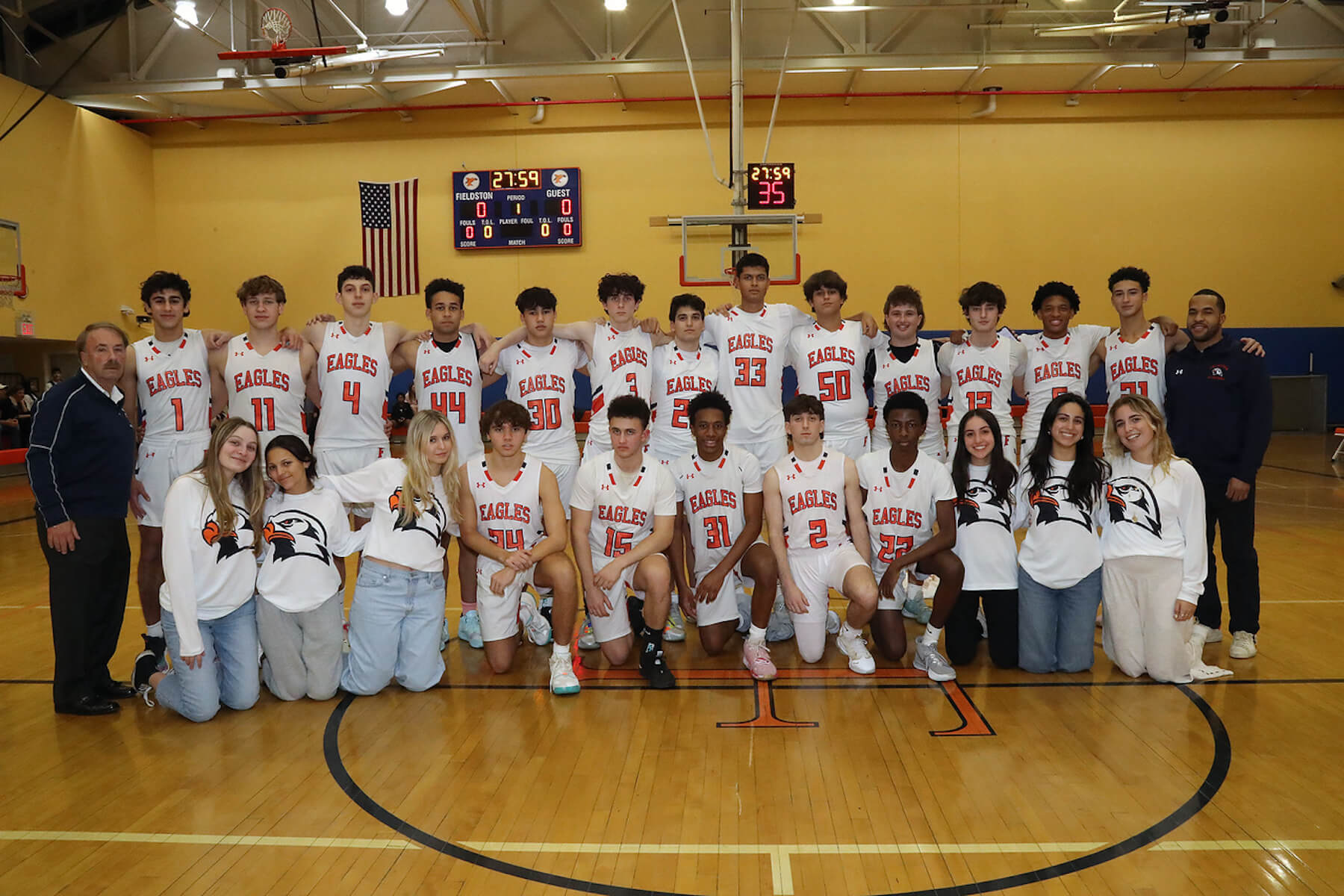 Fieldston Upper boys varsity basketball team poses for group photo in varsity gym.