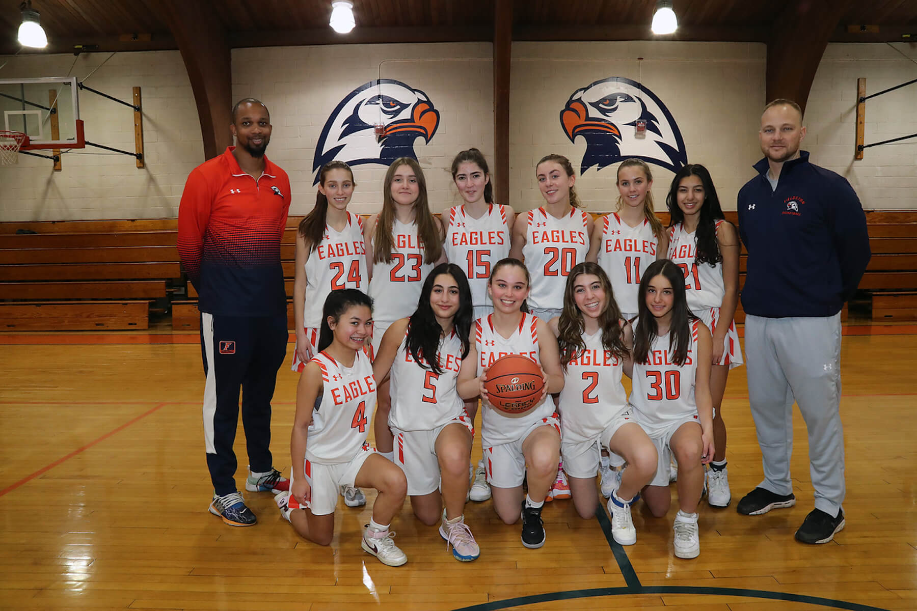 Fieldston Upper girls JV basketball team poses for group photo in gymnasium.