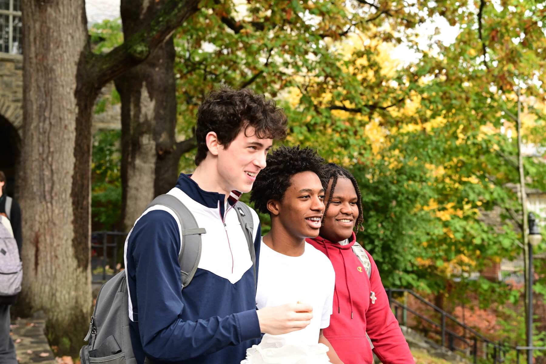 Ethical Culture Fieldston School Upper School students walk through the campus quad