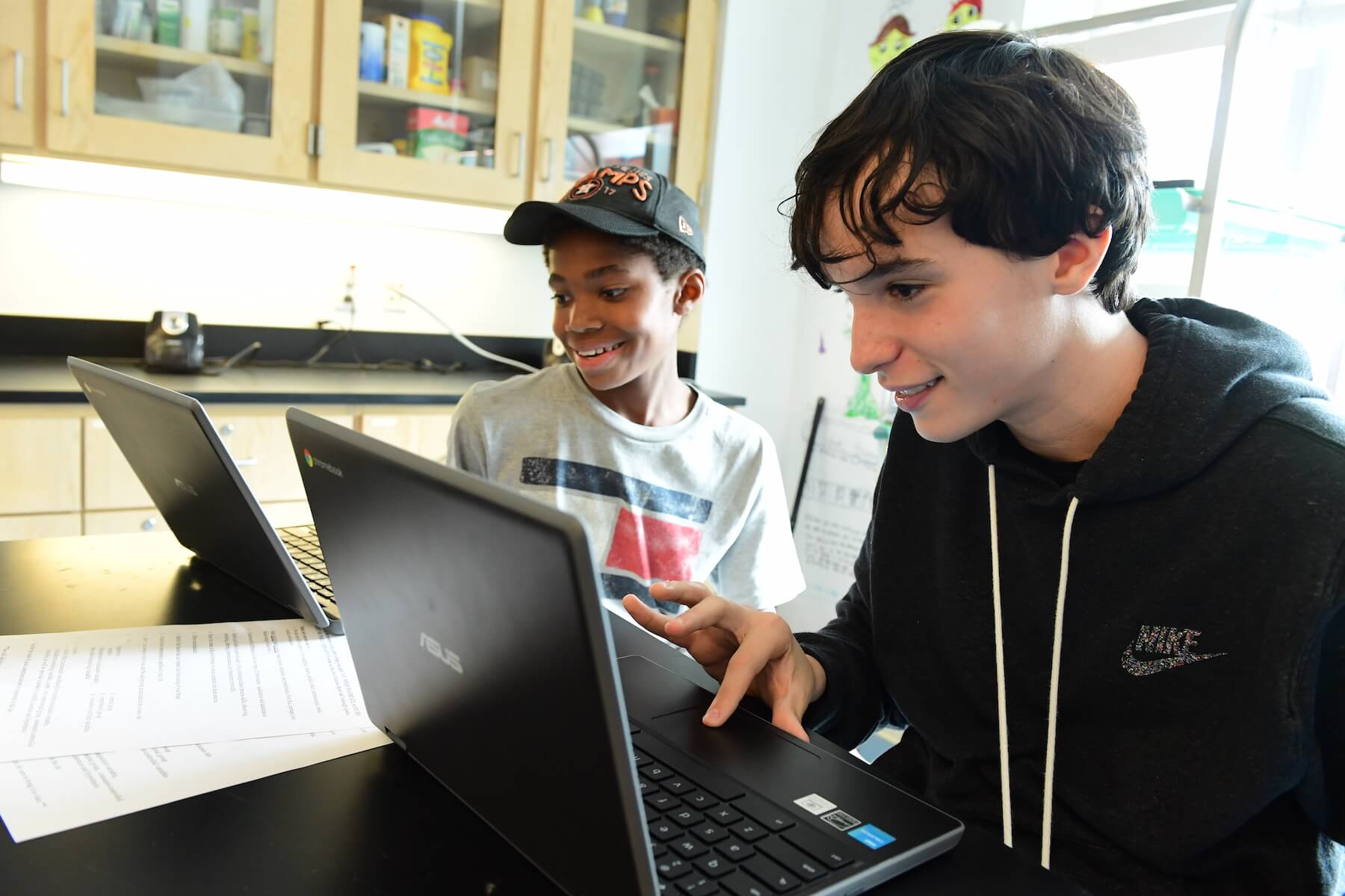 Ethical Culture Fieldston School two Middle School students work together on laptops in the science lab