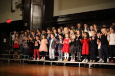 Ethical Culture students sing from the risers at the annual Holiday Assembly.