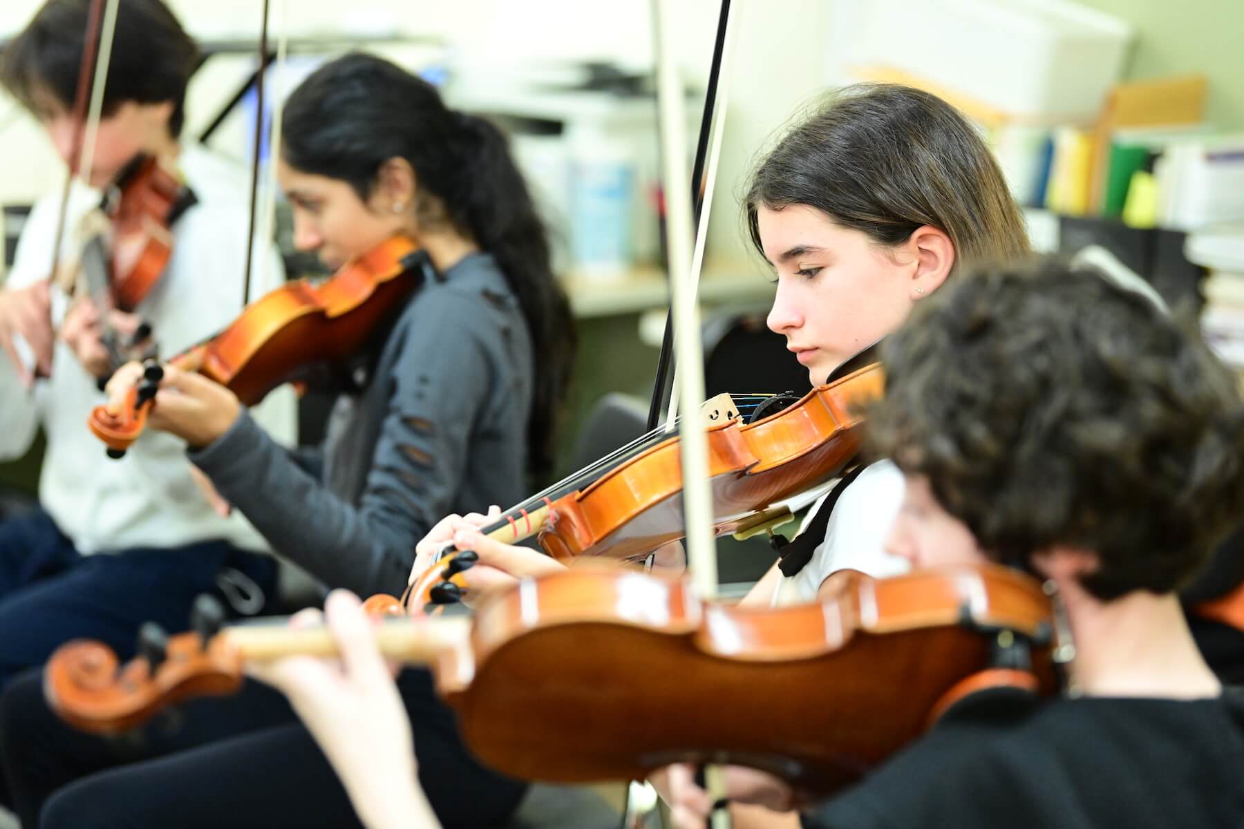 Ethical Culture Fieldston School students practicing on violins in strings class