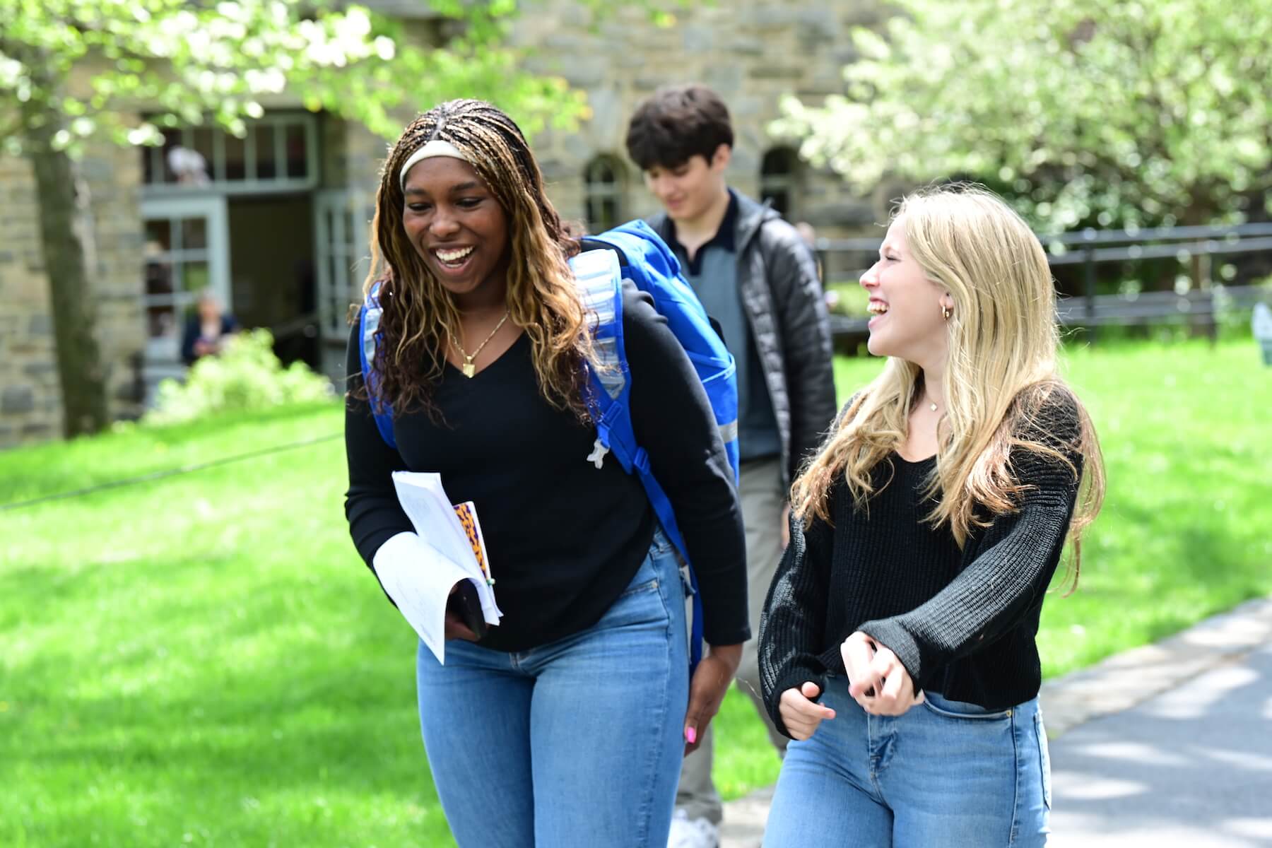 Ethical Culture Fieldston School Fieldston Upper students walk through the quad talking to each other during the College Symposium