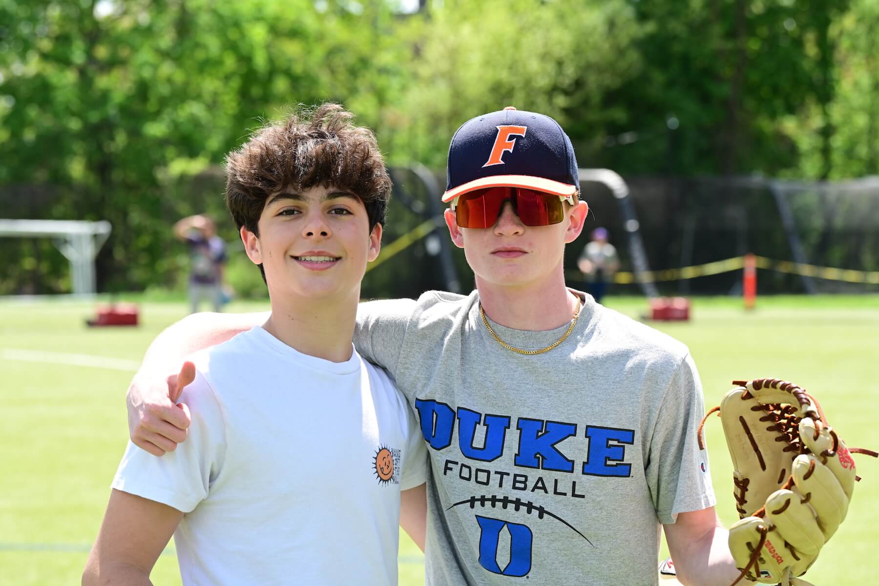 Ethical Culture Fieldston School Fieldston Middle students smile for camera on the field during baseball