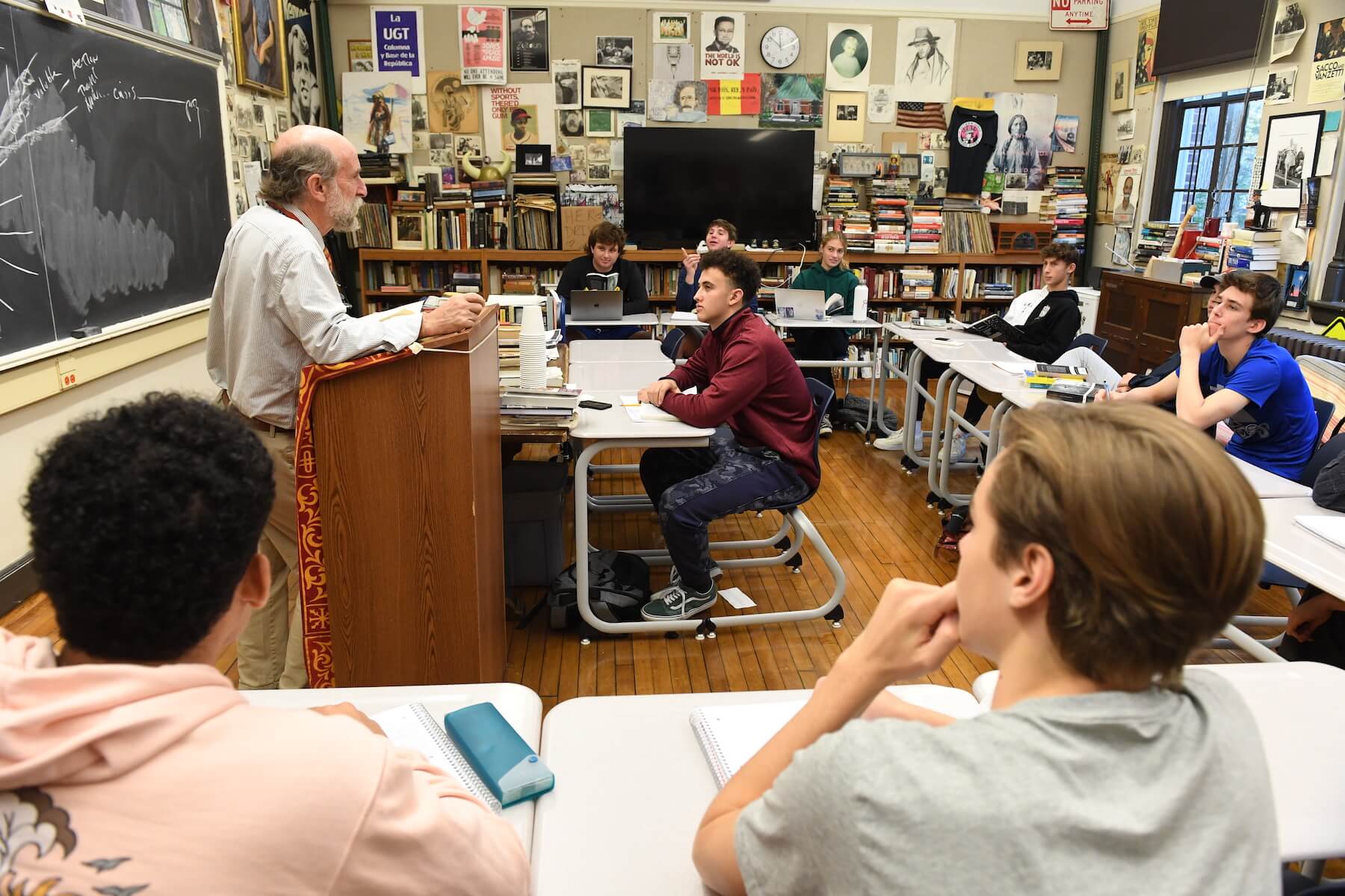 Ethical Culture Fieldston School Upper School students listen at desks in class