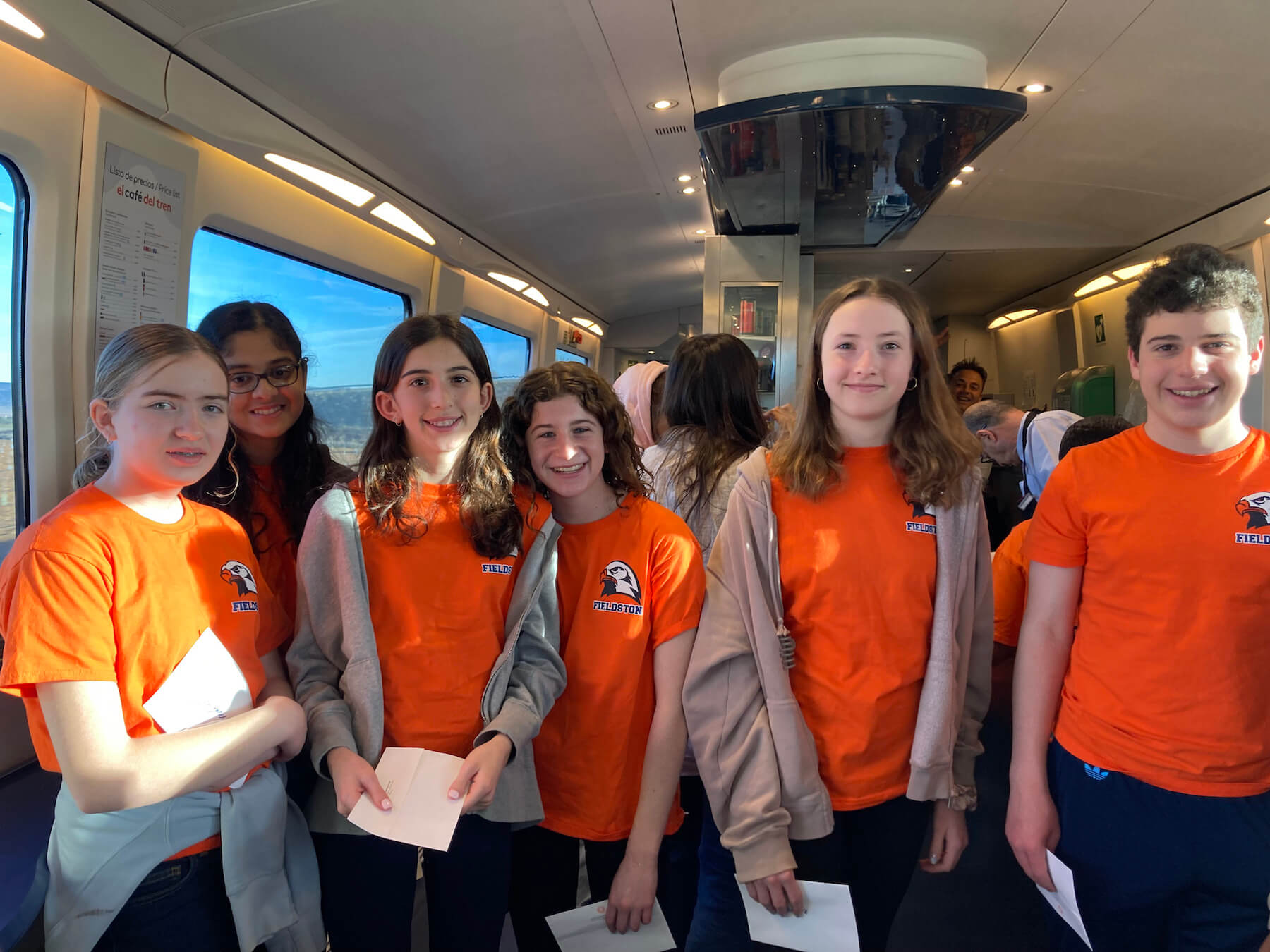 Group of Ethical Culture Fieldston School Middle School students on a train traveling during trip abroad to Spain