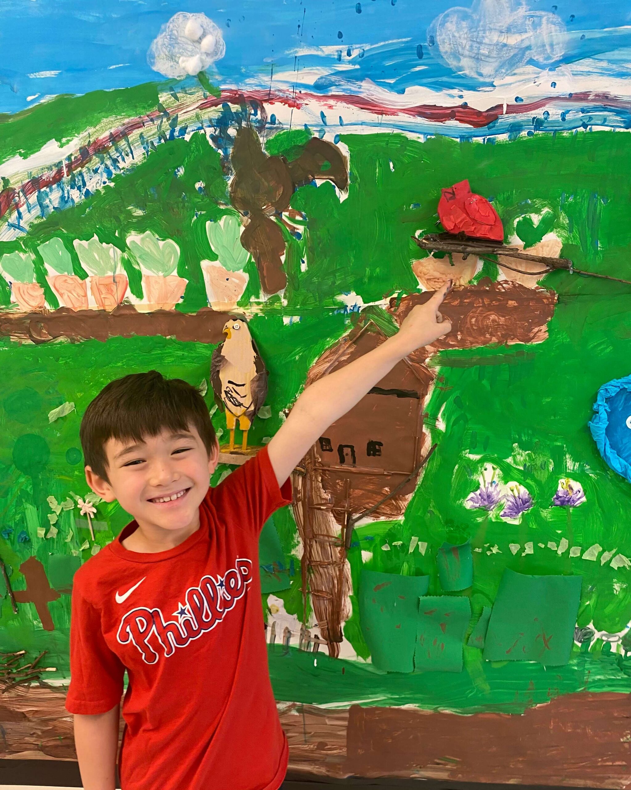 Ethical Culture Fieldston School Fieldston Lower student proudly points to his bird created in the 1st Grade Bird Museum