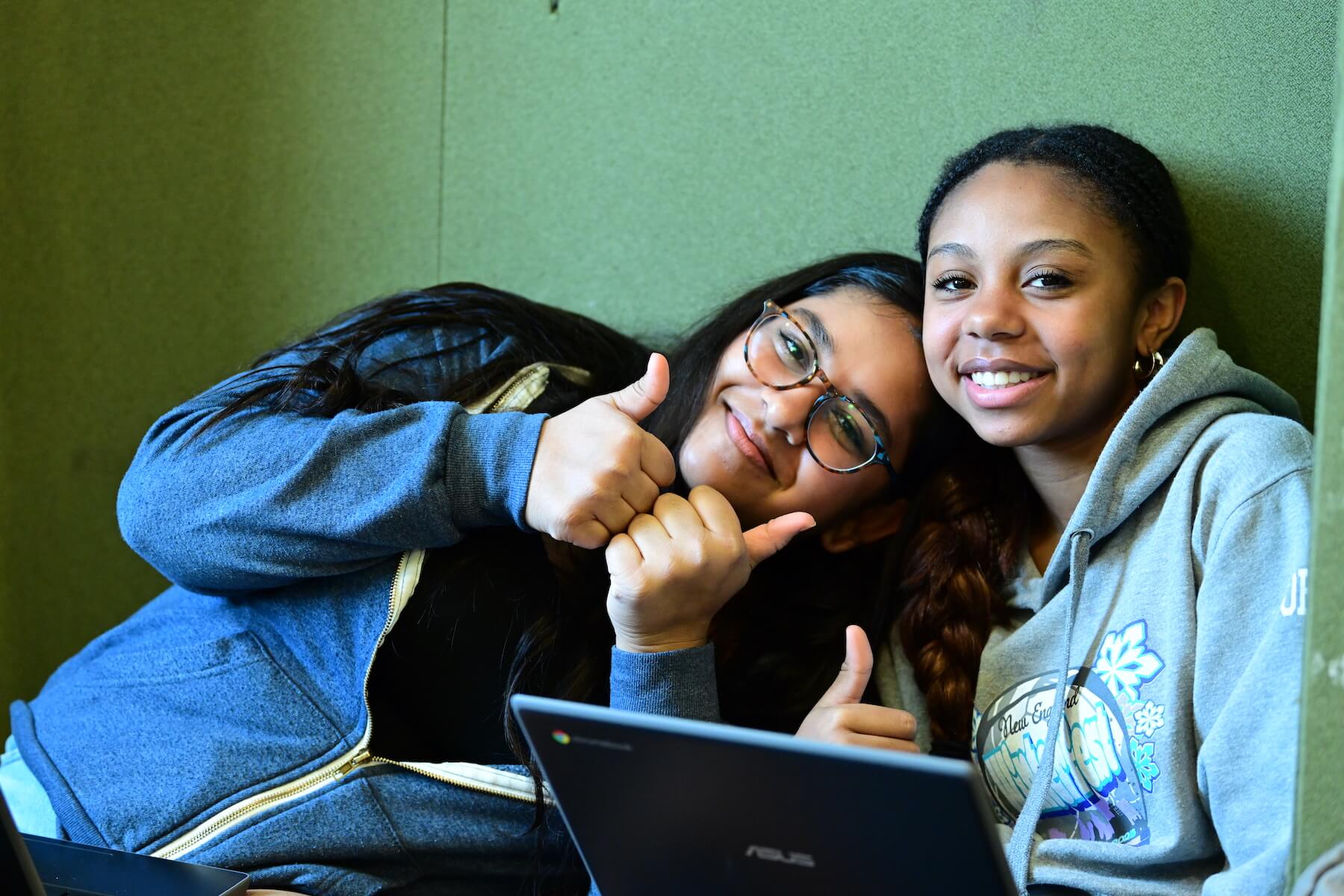 Ethical Culture Fieldston School Middle School students smile with thumbs up