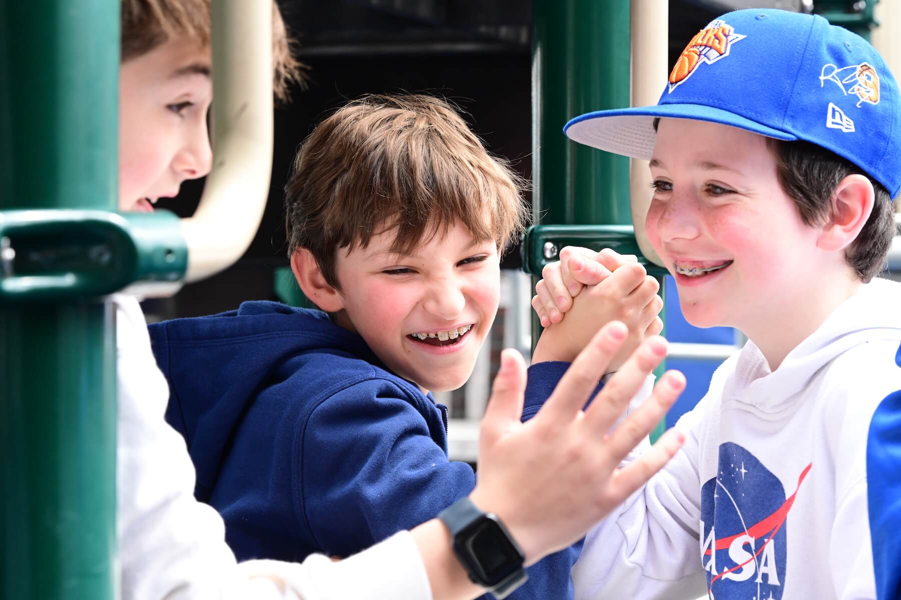 Ethical Culture Fieldston School Ethical Culture students playfully arm wrestle on the playground