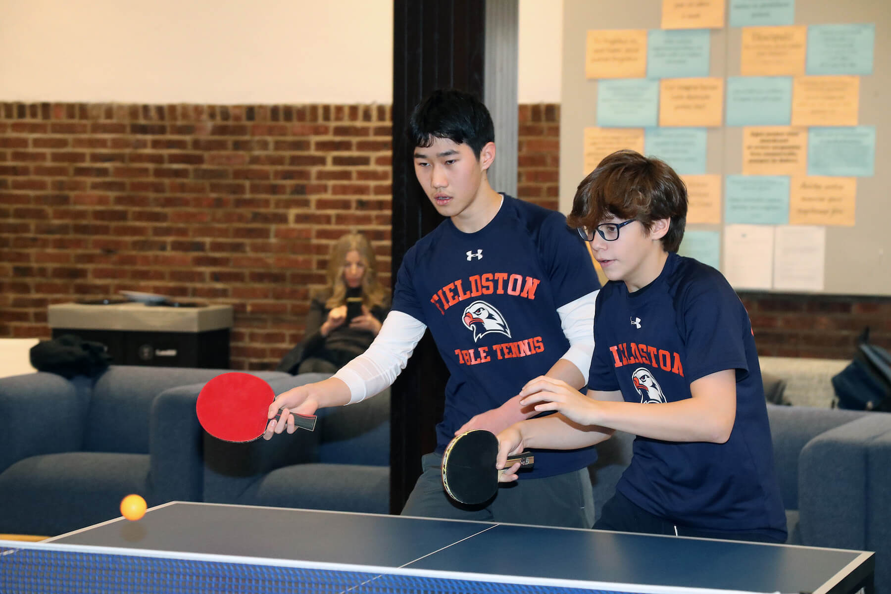 Ethical Culture Fieldston School Ping Pong Team members enjoy a game together