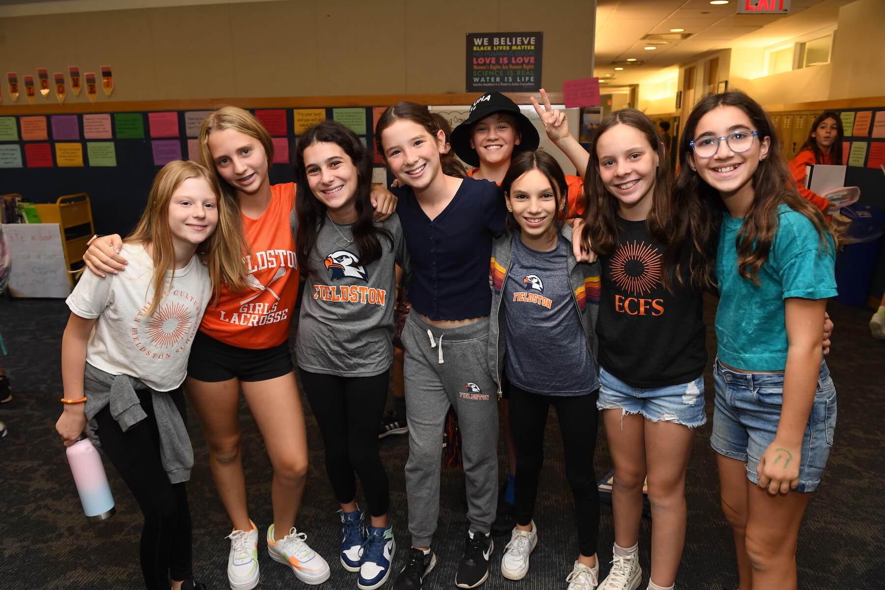 Ethical Culture Fieldston School Middle School students gather in a common area for a photo