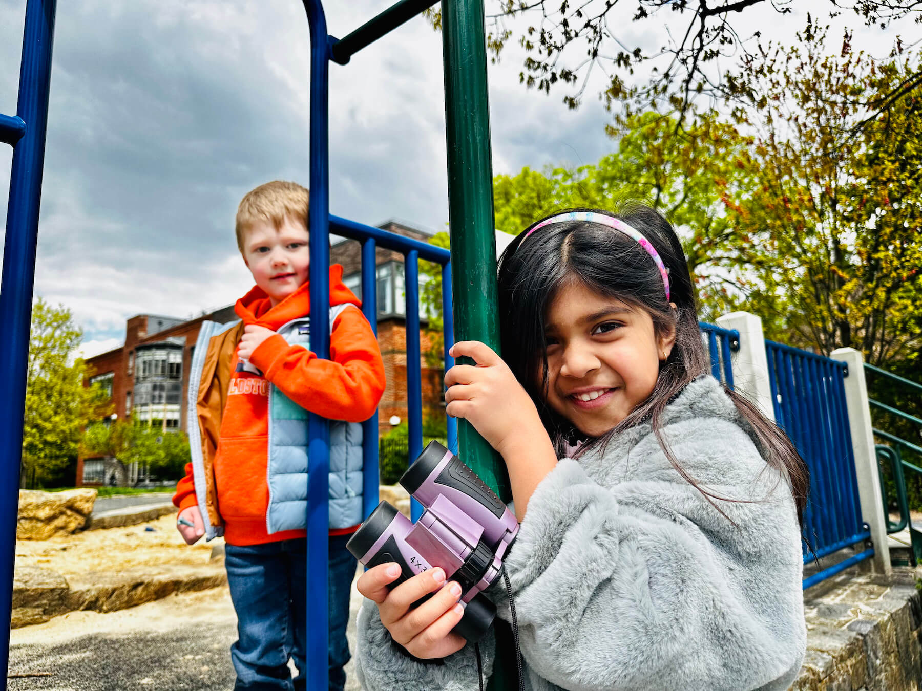 Ethical Culture Fieldston School Fieldston Lower students smile at camera while playing on playground