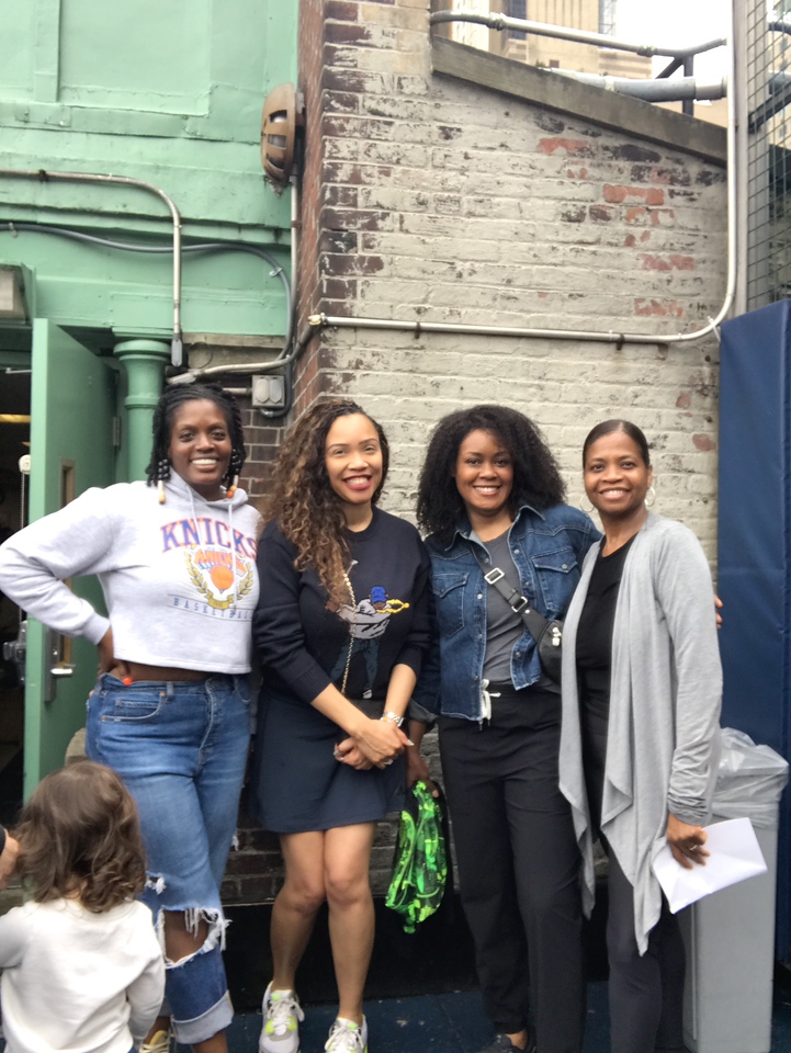ethical culture fieldston school ethical culture parents smile together on the rooftop at Spring Fest community celebration.